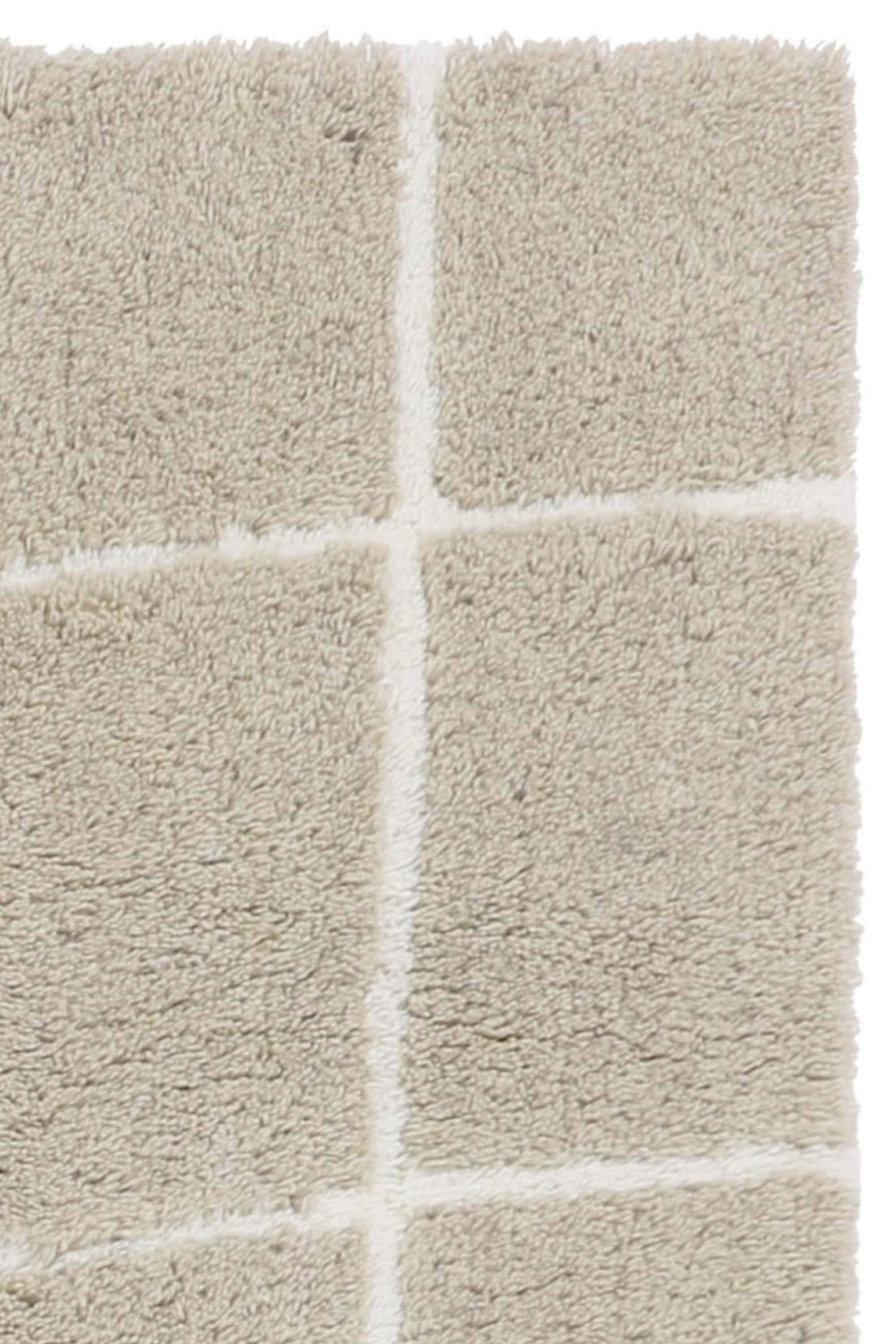 Beige woollen rug with white line feature