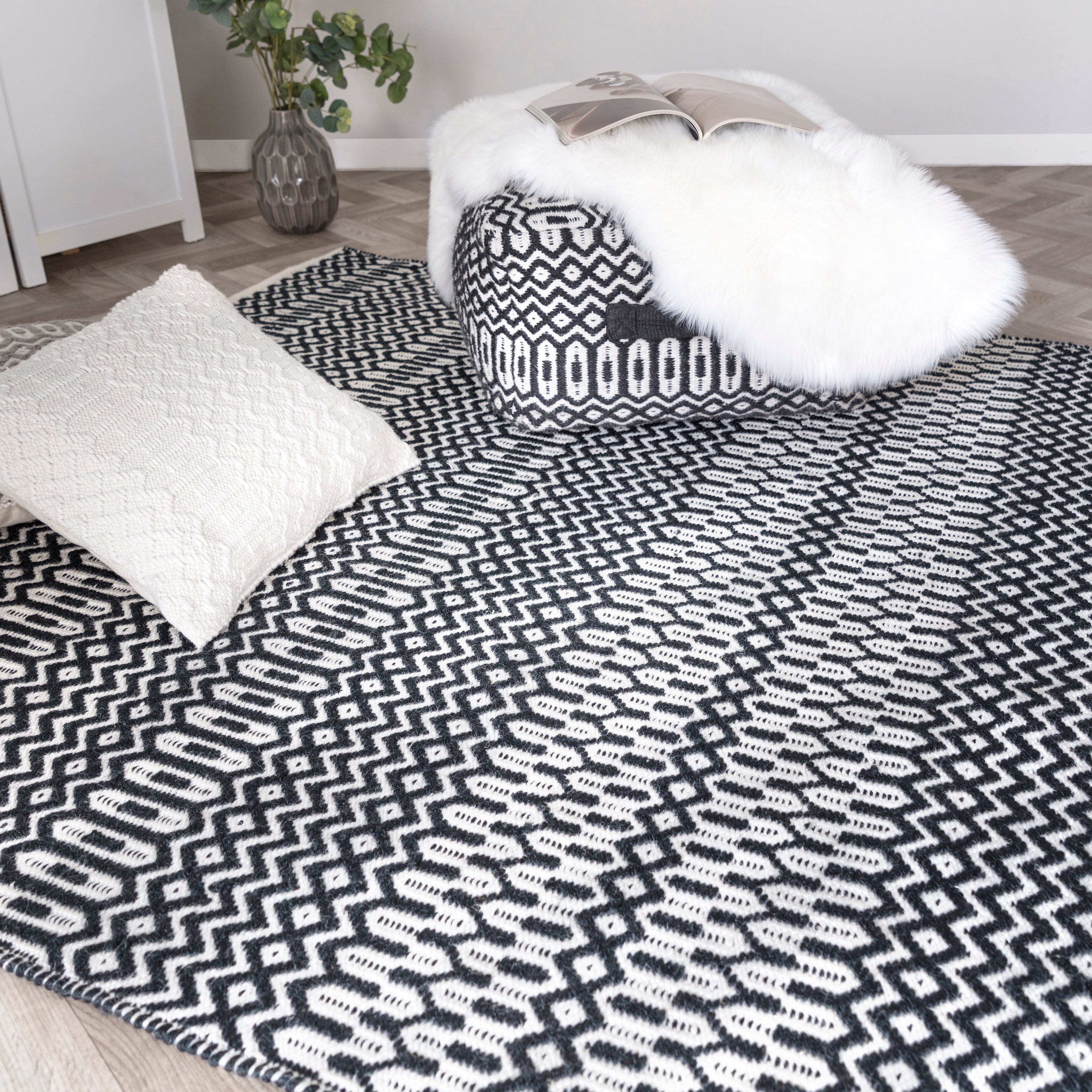 black indoor/outdoor rug with geometric design