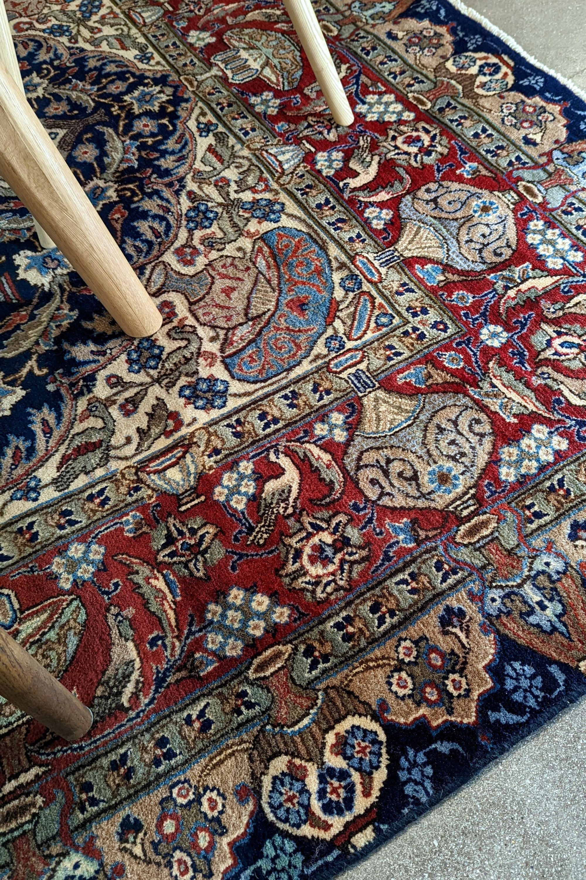 Authentic persian rug with a traditional floral design in red