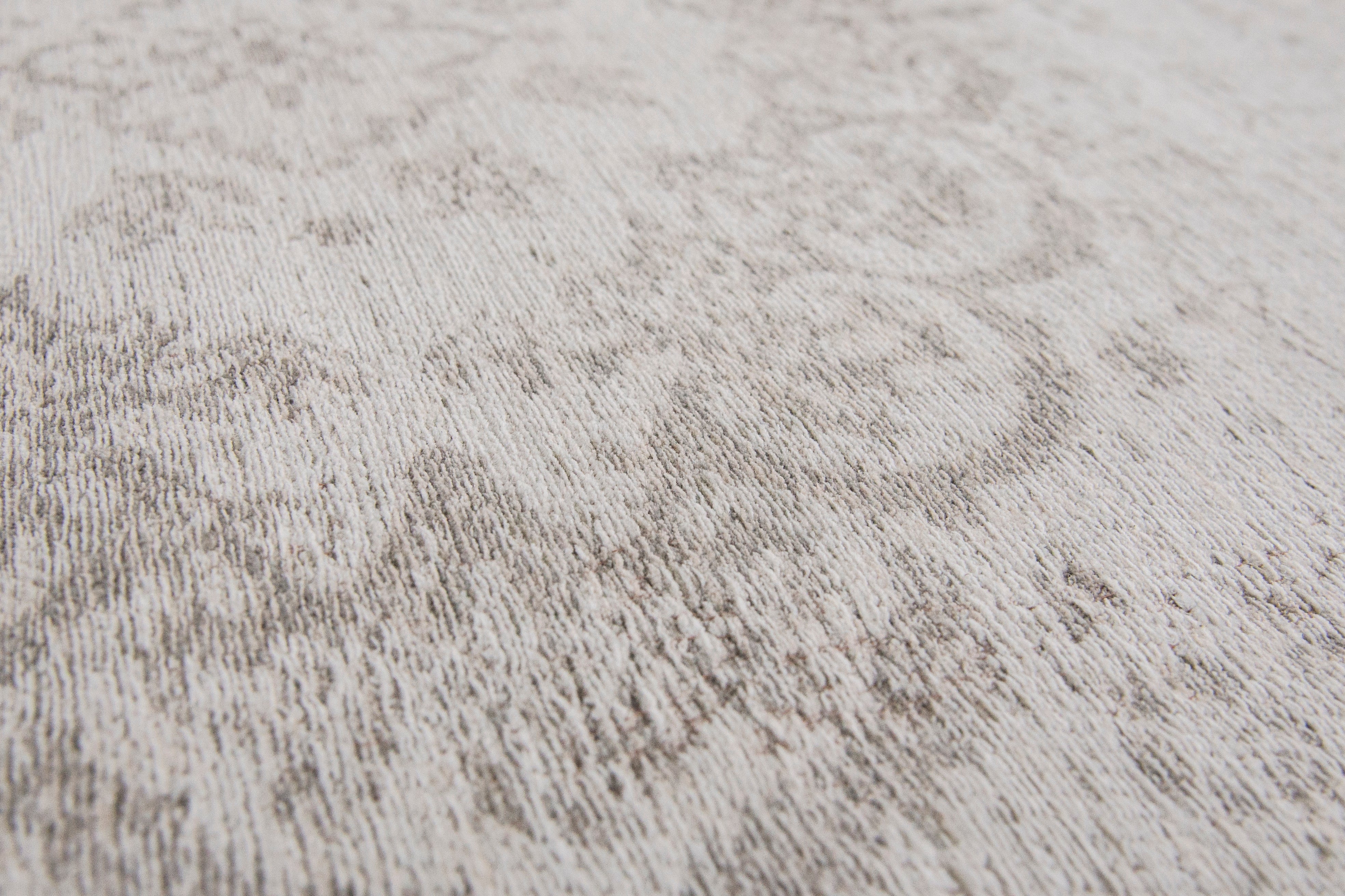 Grey rug with faded persian design