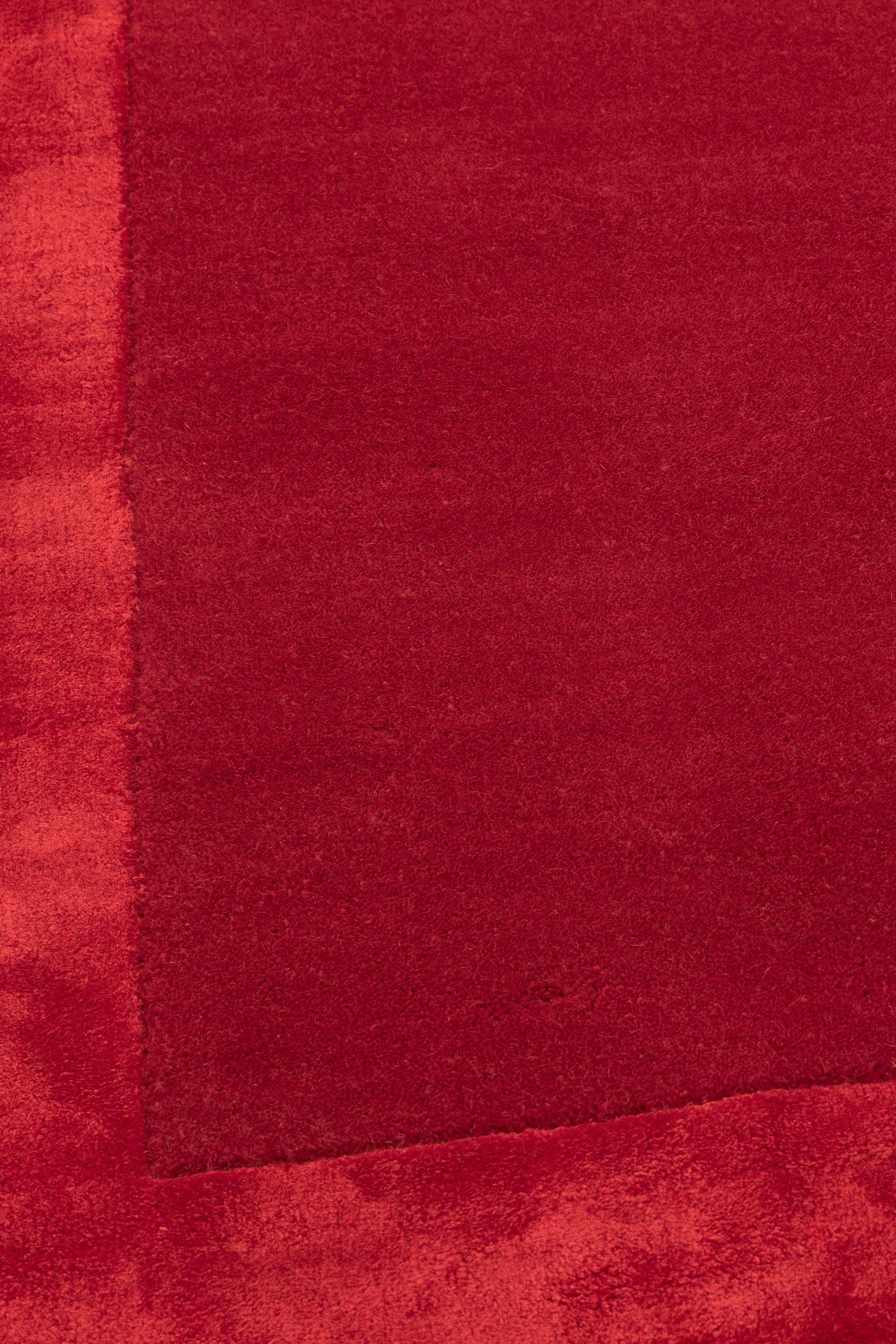 red wool and viscose rug with a border design