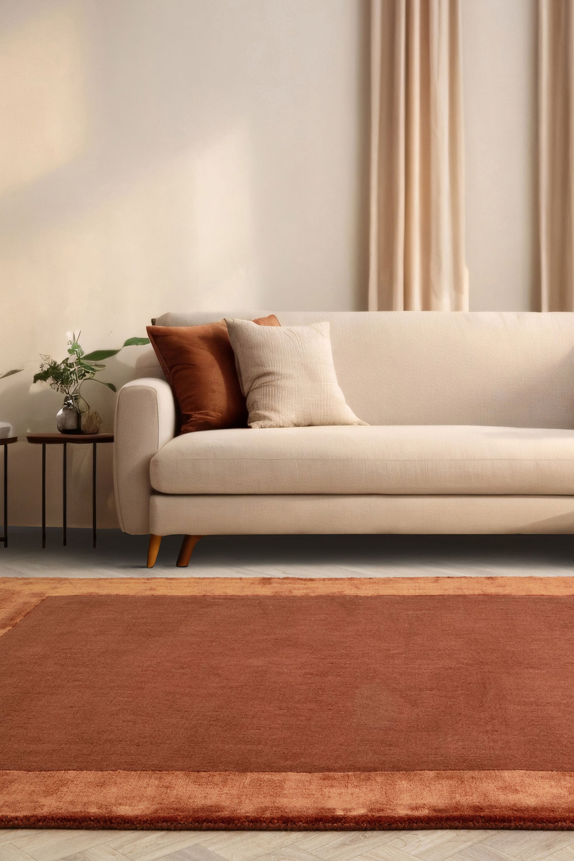 Orange wool and viscose rug with a border design