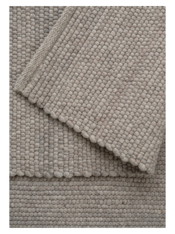 Light grey textured woven rug