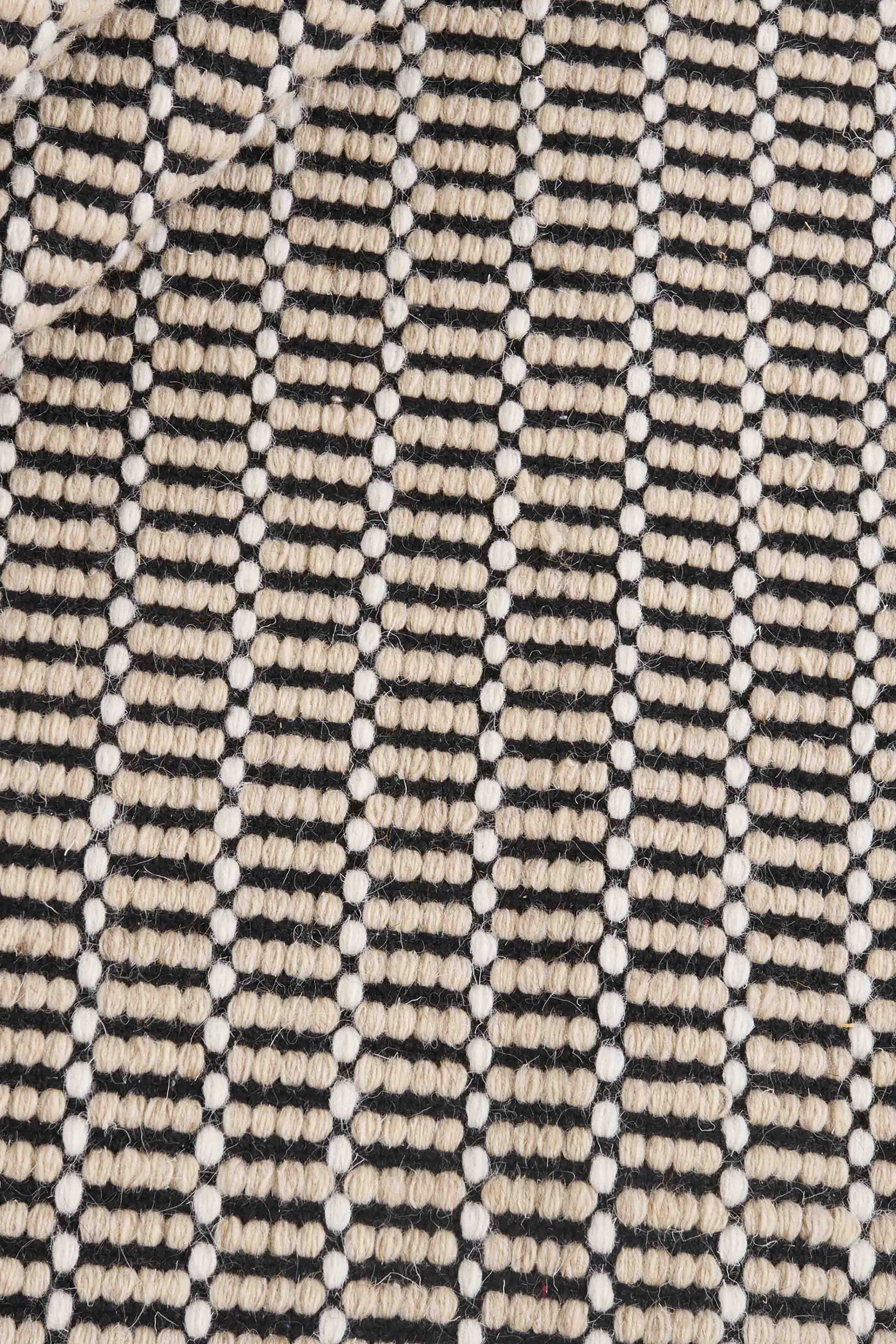Luxury cream and black woven rug