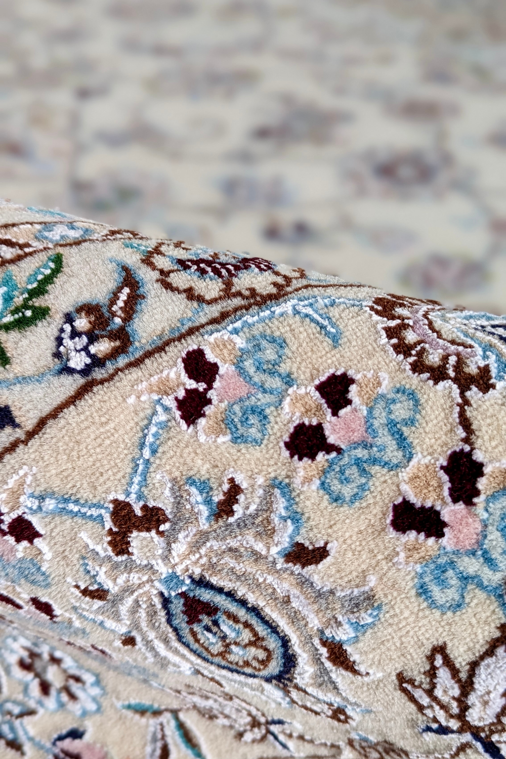 Authentic oriental rug with traditional floral design in cream, ivory and blue