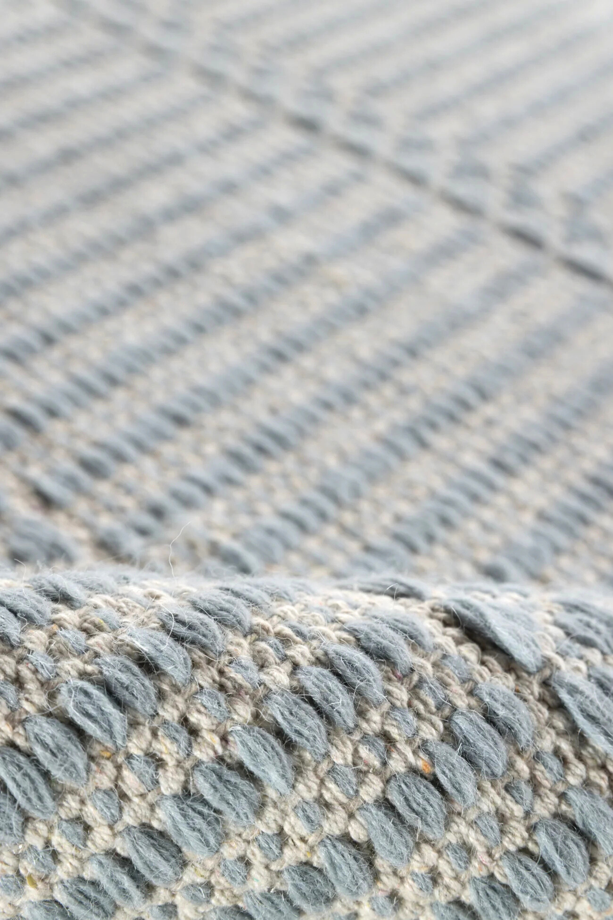 Blue wool and cotton rug featuring a design inspired by ancient irish script