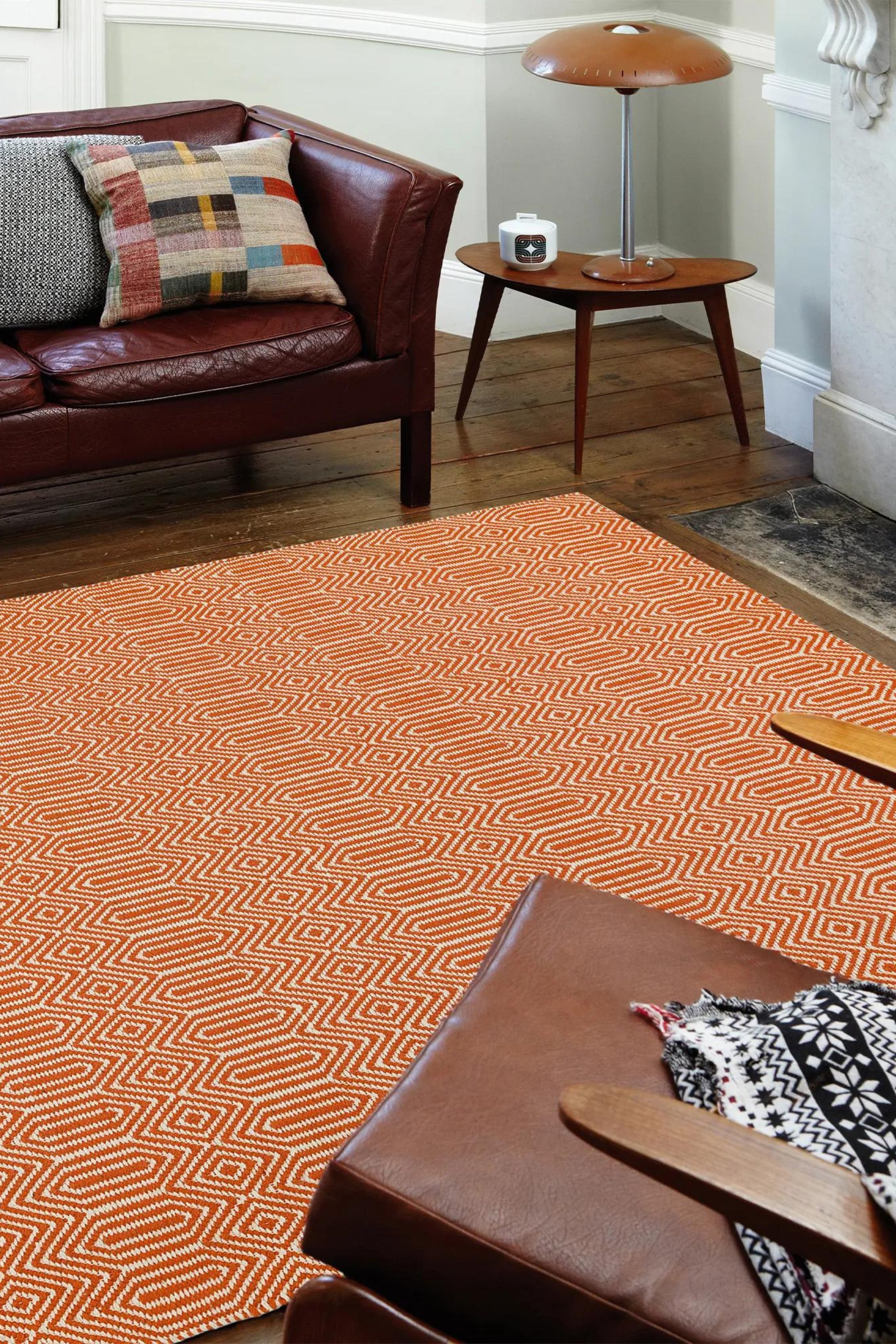 orange and white woven rug with aztec chevron pattern
