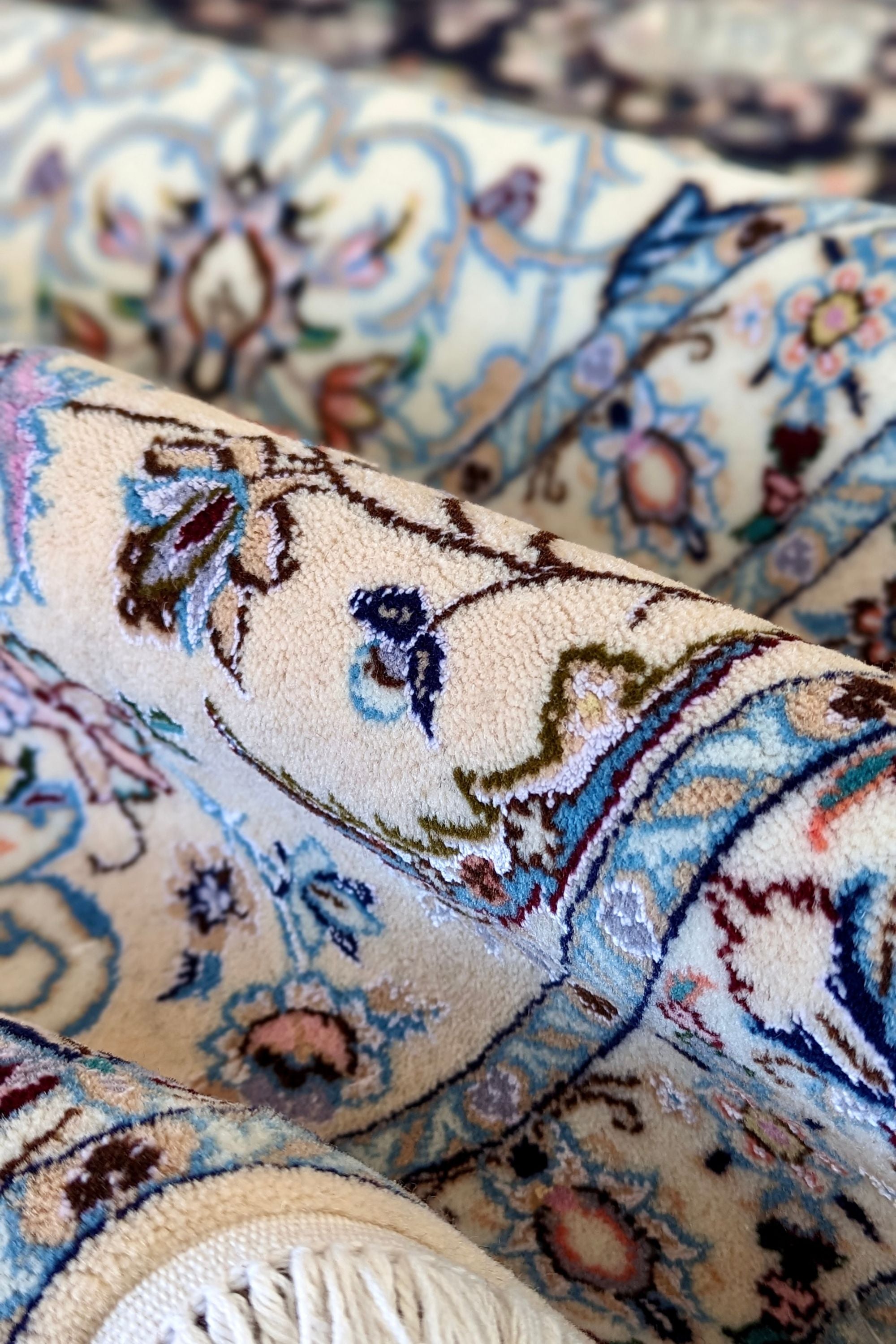 Authentic oriental rug with traditional floral design in cream, navy, blue and pink