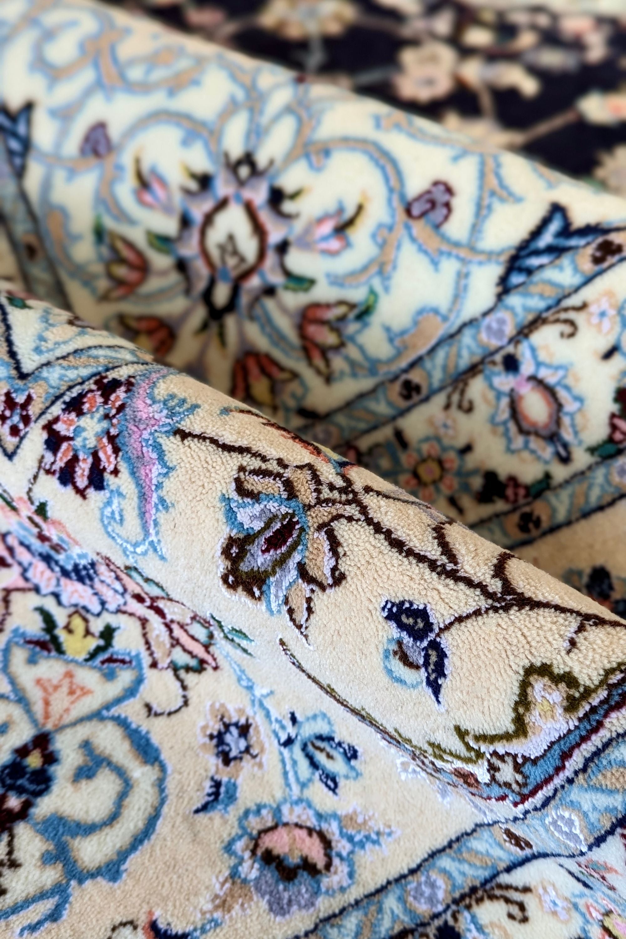 Authentic oriental rug with traditional floral design in cream, navy, blue and pink