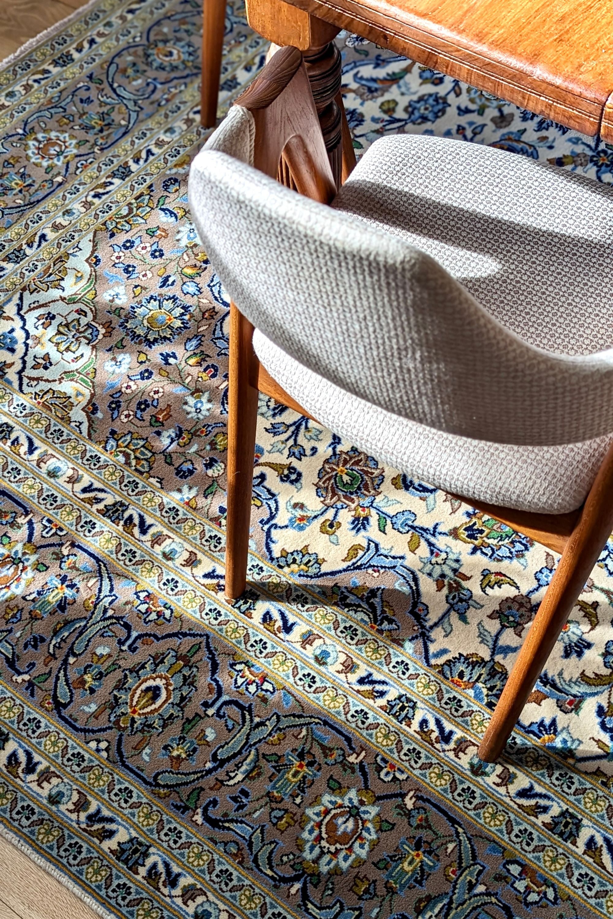Authentic persian rug with traditional floral design in beige and blue
