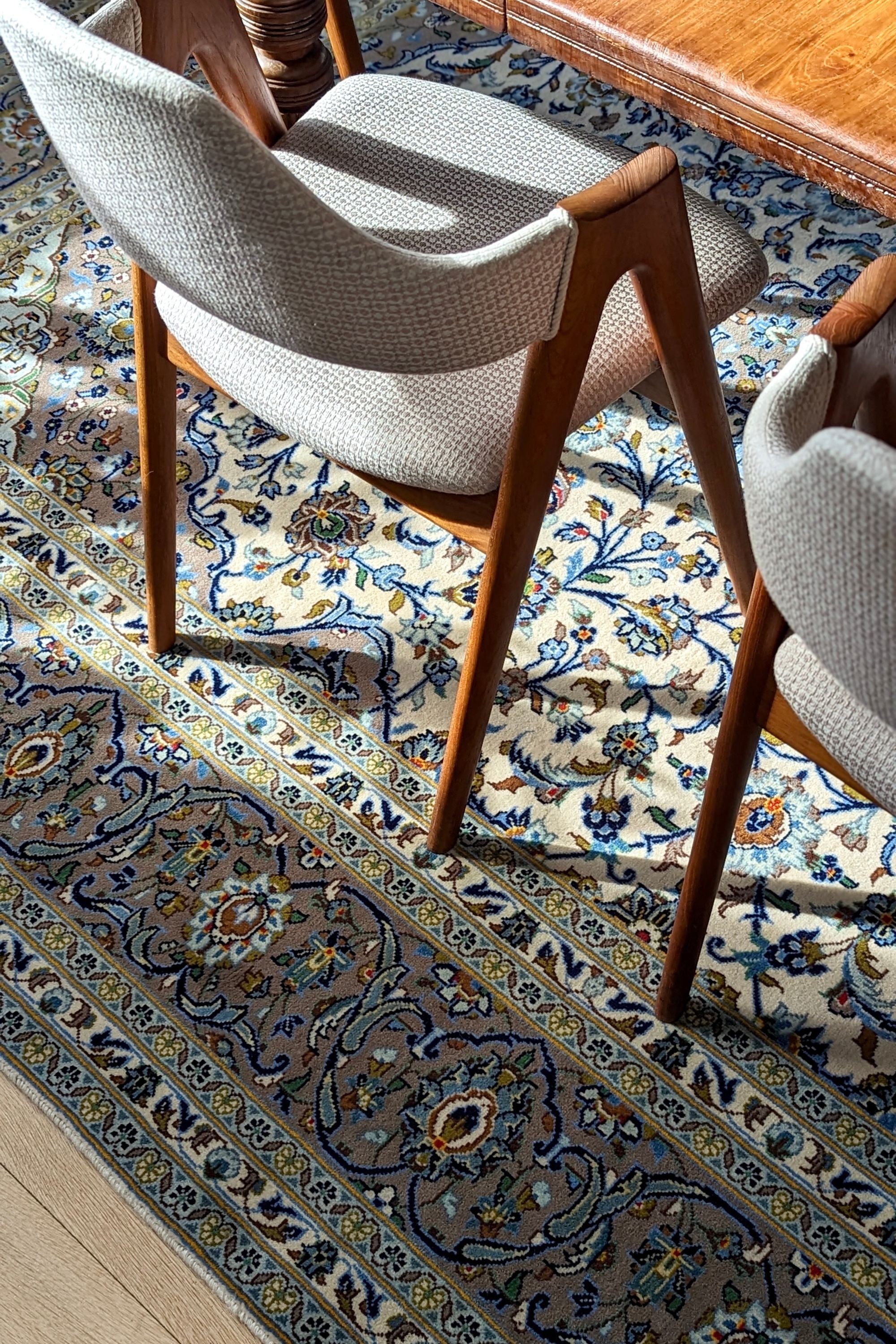 Authentic persian rug with traditional floral design in beige and blue