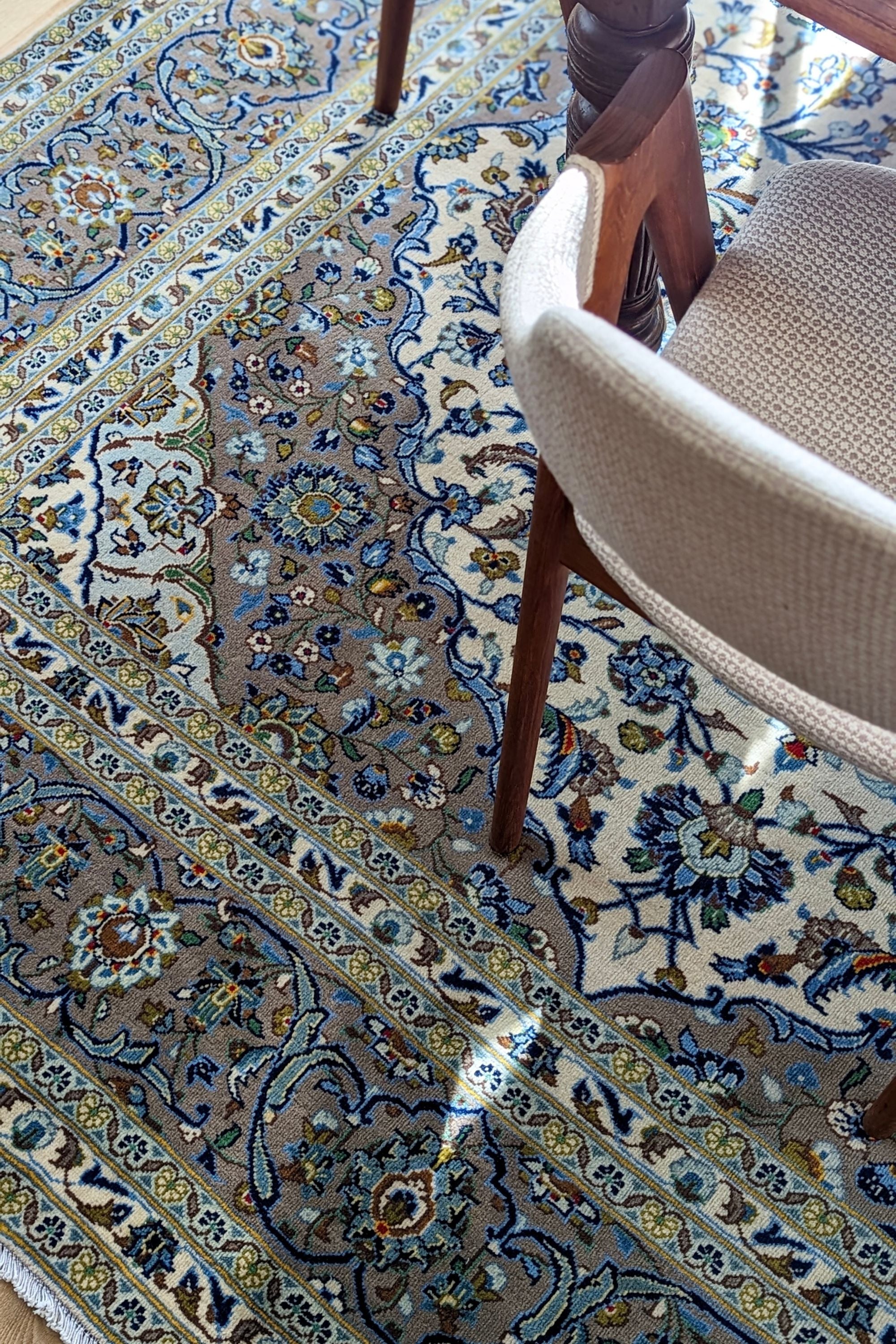 Authentic persian rug with traditional floral design in beige and blue