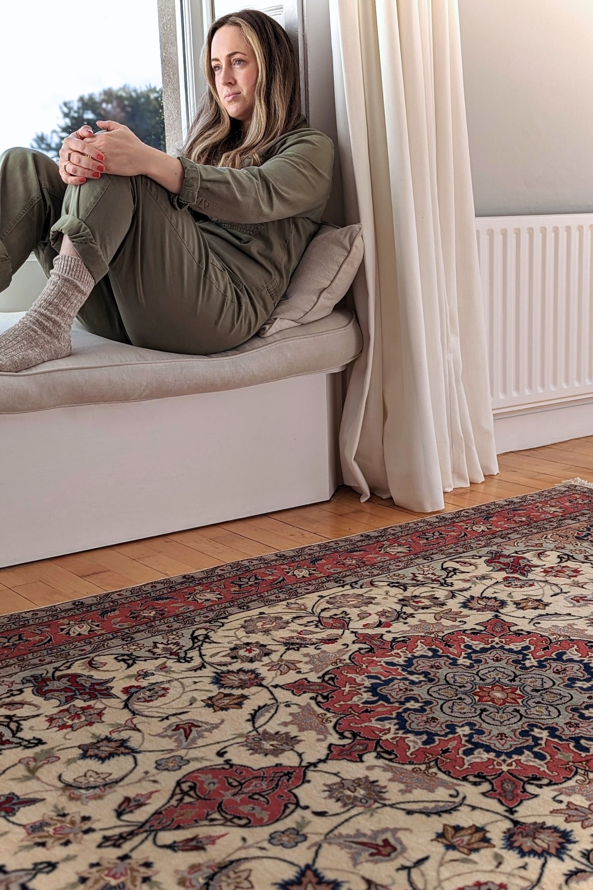 Authentic persian rug with traditional floral design in red, blue and beige