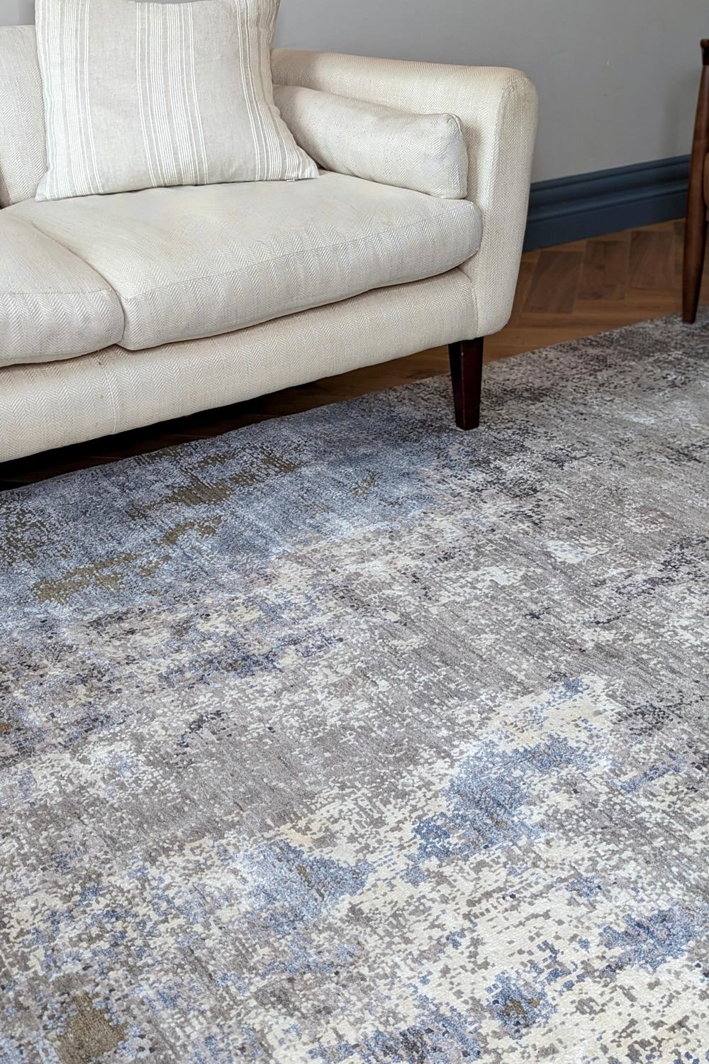 Large area rug with abstract design in grey and beige