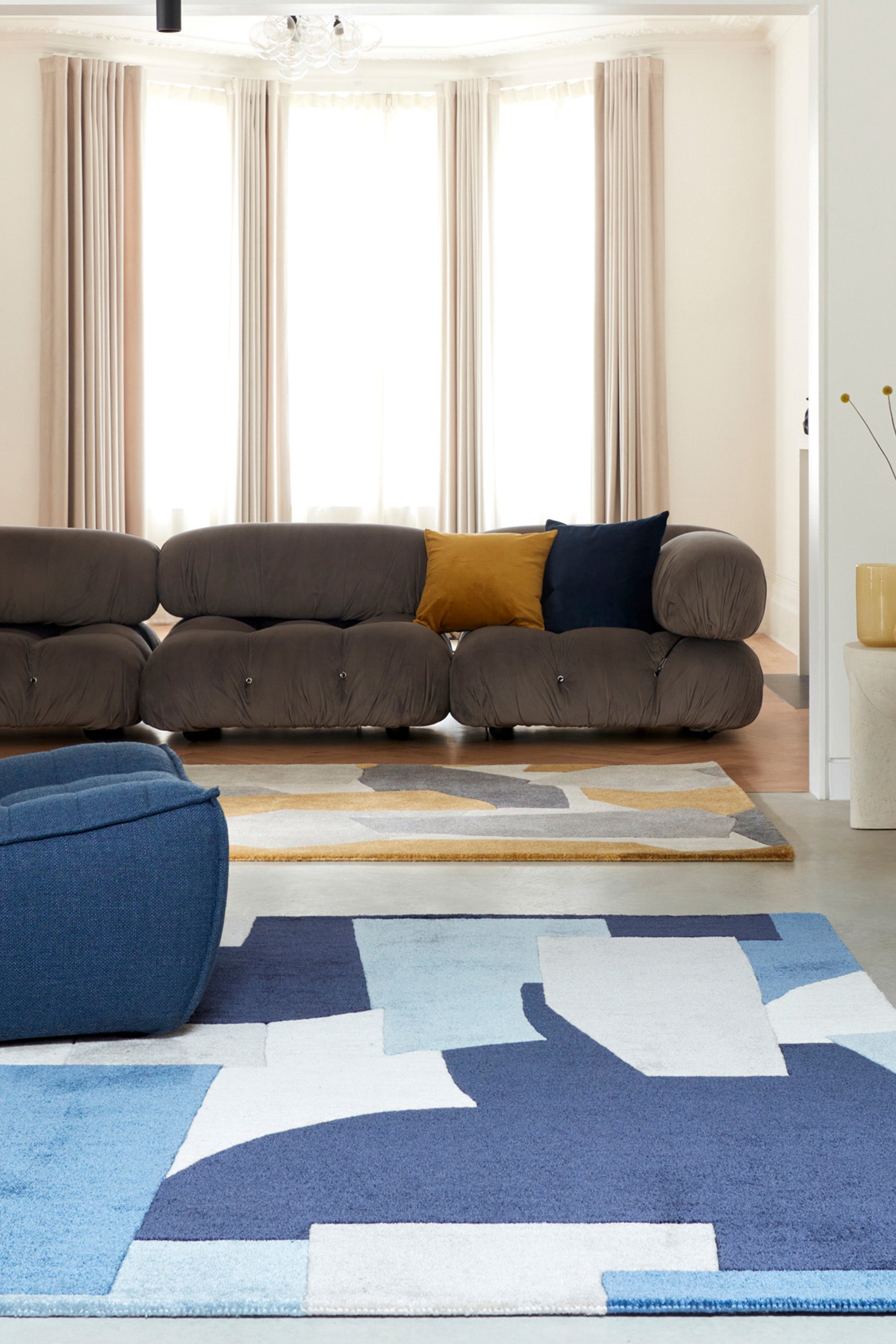 Multicolour rug with abstract pattern in blue, grey, and cream tones