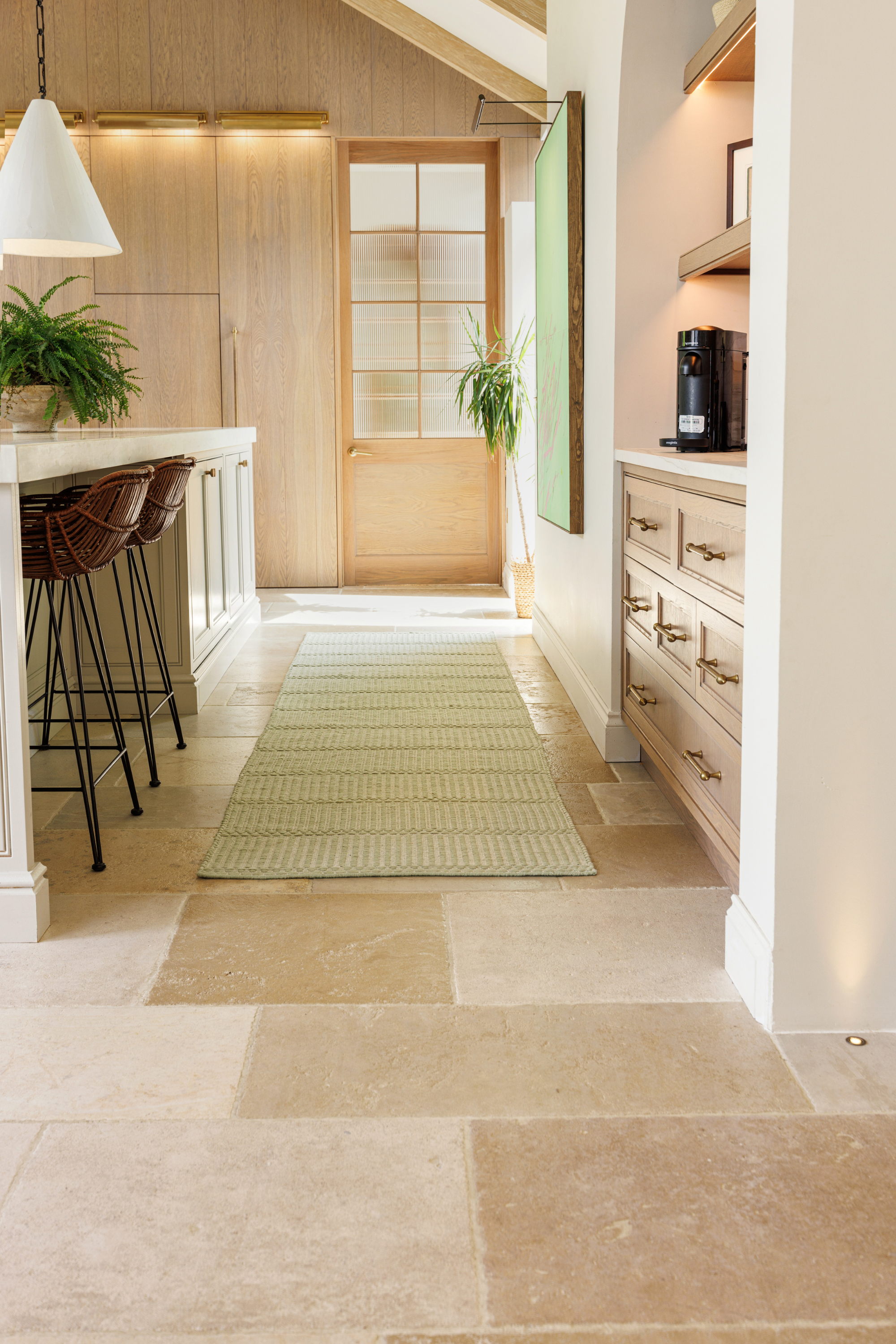 wool and cotton runner rug in soft olive hues featuring a design inspired by ancient irish script placed in a kitchen