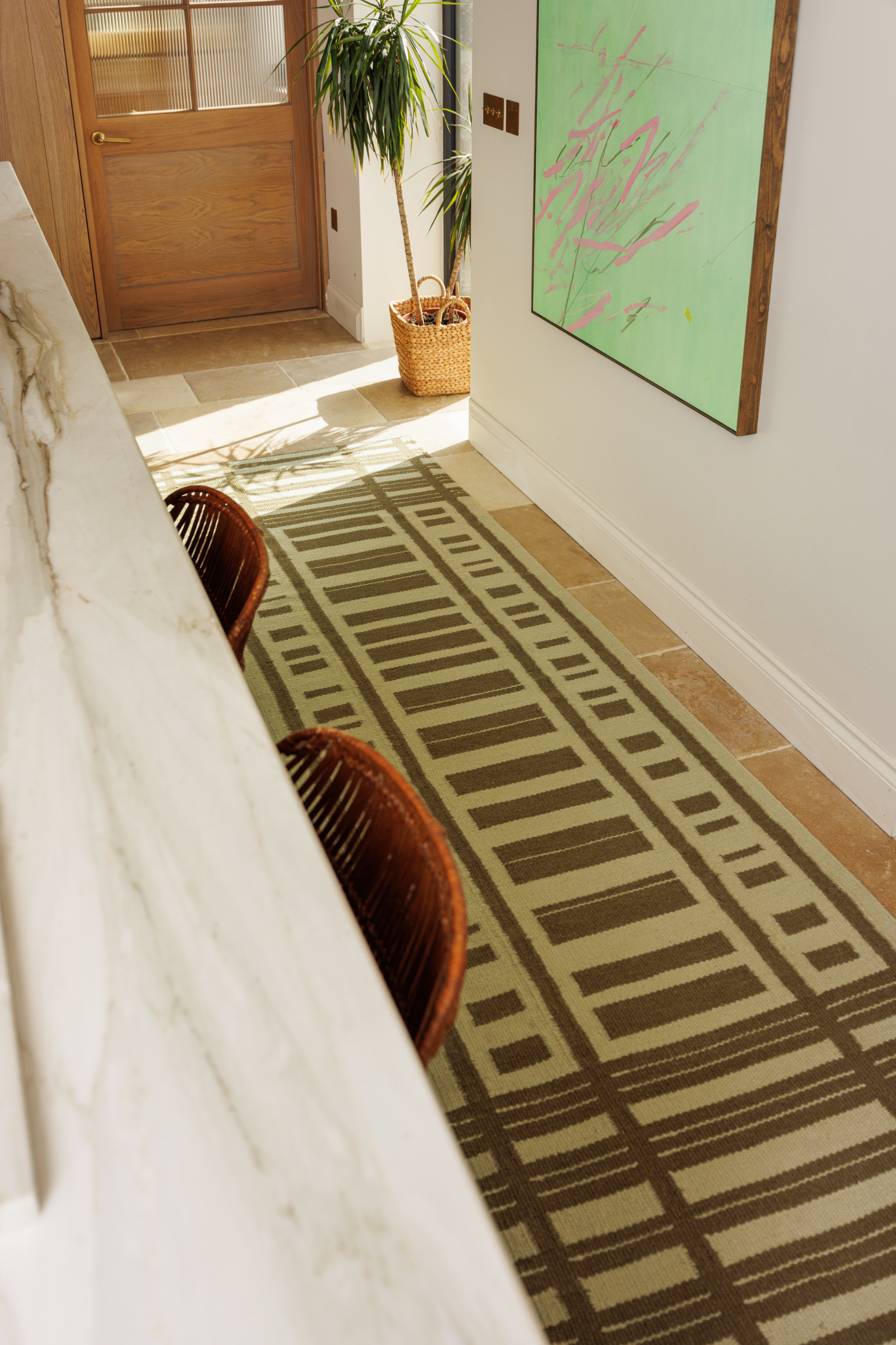 Tonal green wool and cotton runner rug featuring a contrasting linear pattern placed in a kitchen