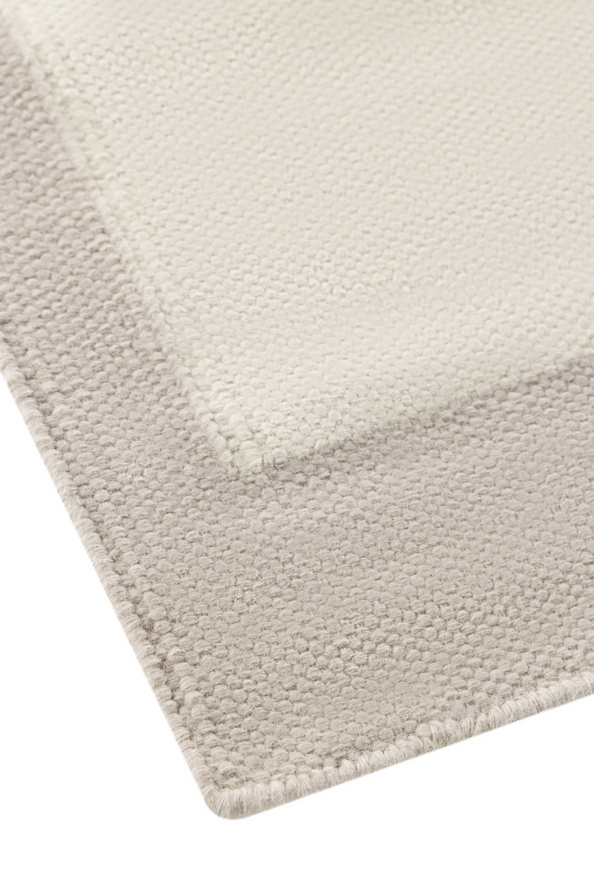 Neutral greige wool and cotton rug featuring an ivory angular design