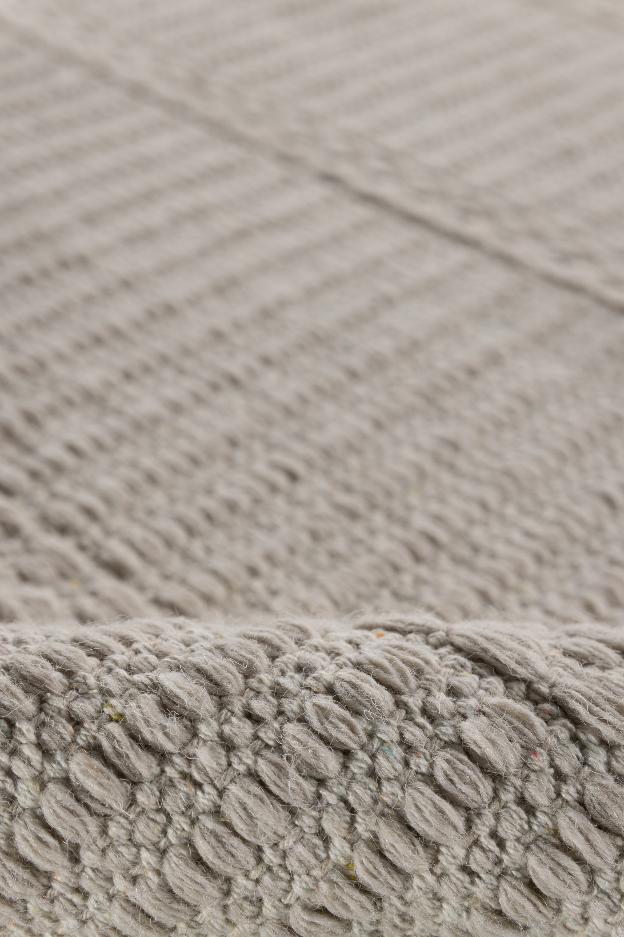 beige wool and cotton runner rug featuring a design inspired by ancient irish script