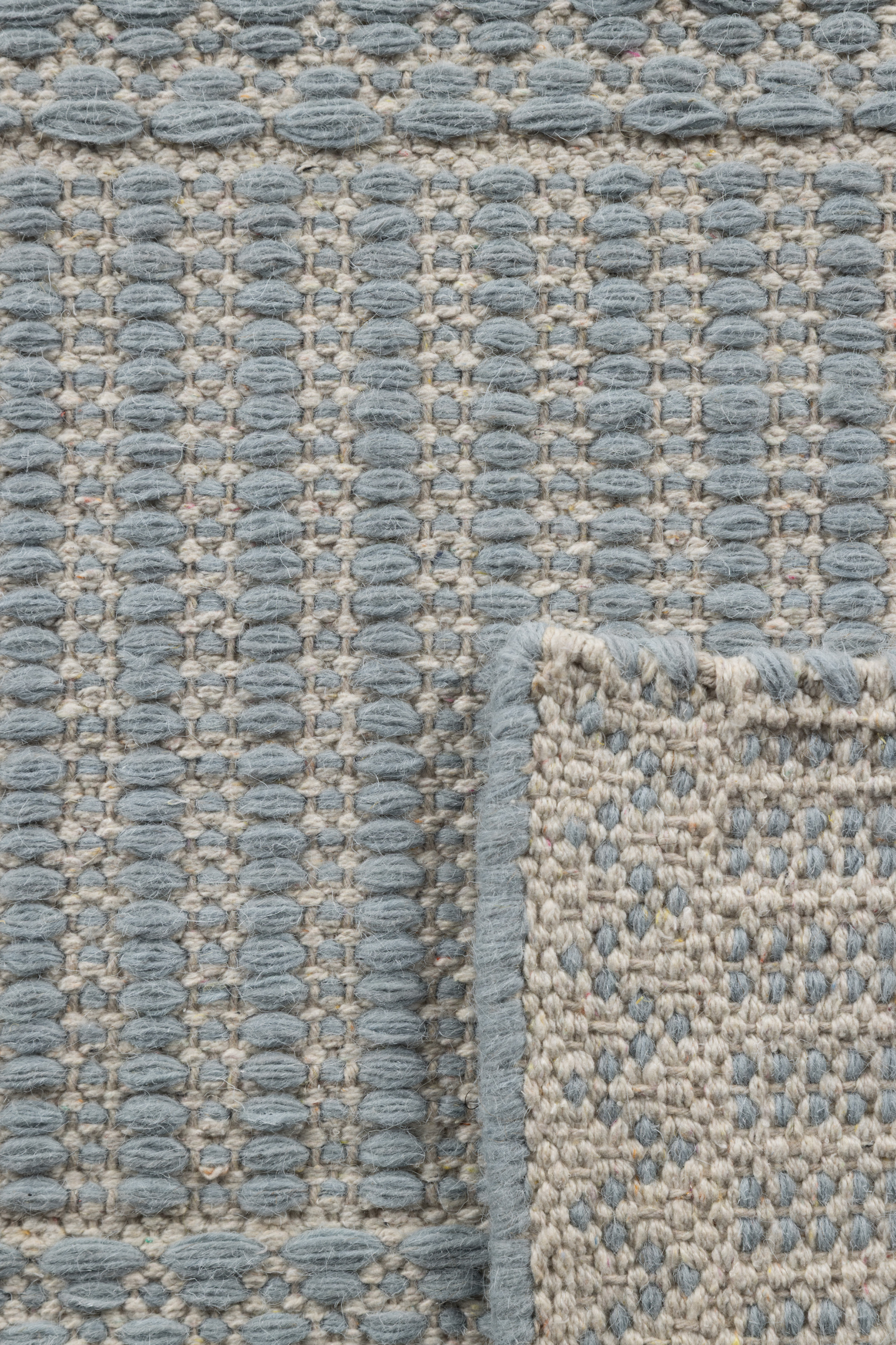 Blue wool and cotton runner rug featuring a design inspired by ancient irish script