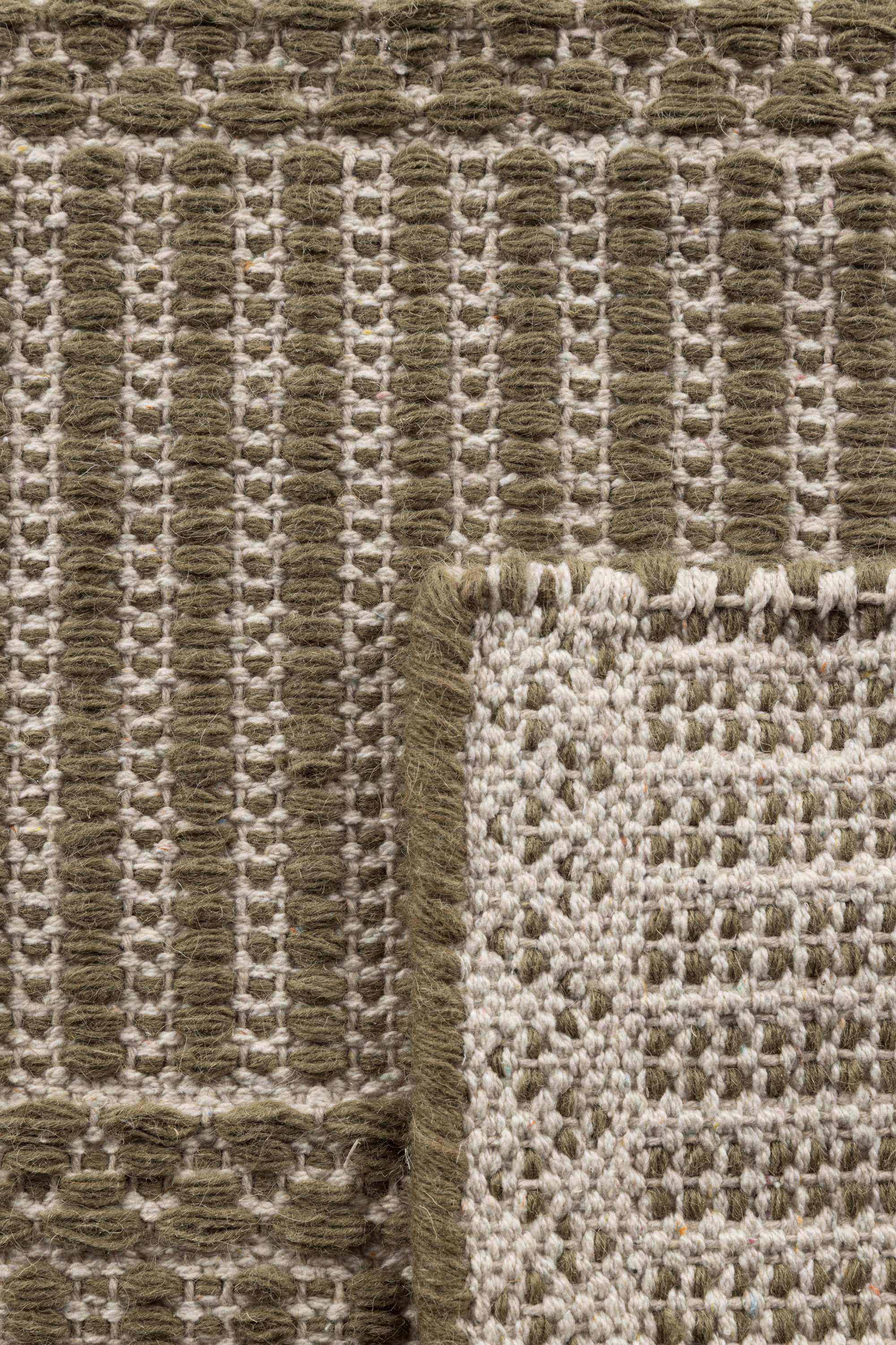 wool and cotton runner rug in dark green moss tones featuring a design inspired by ancient irish script