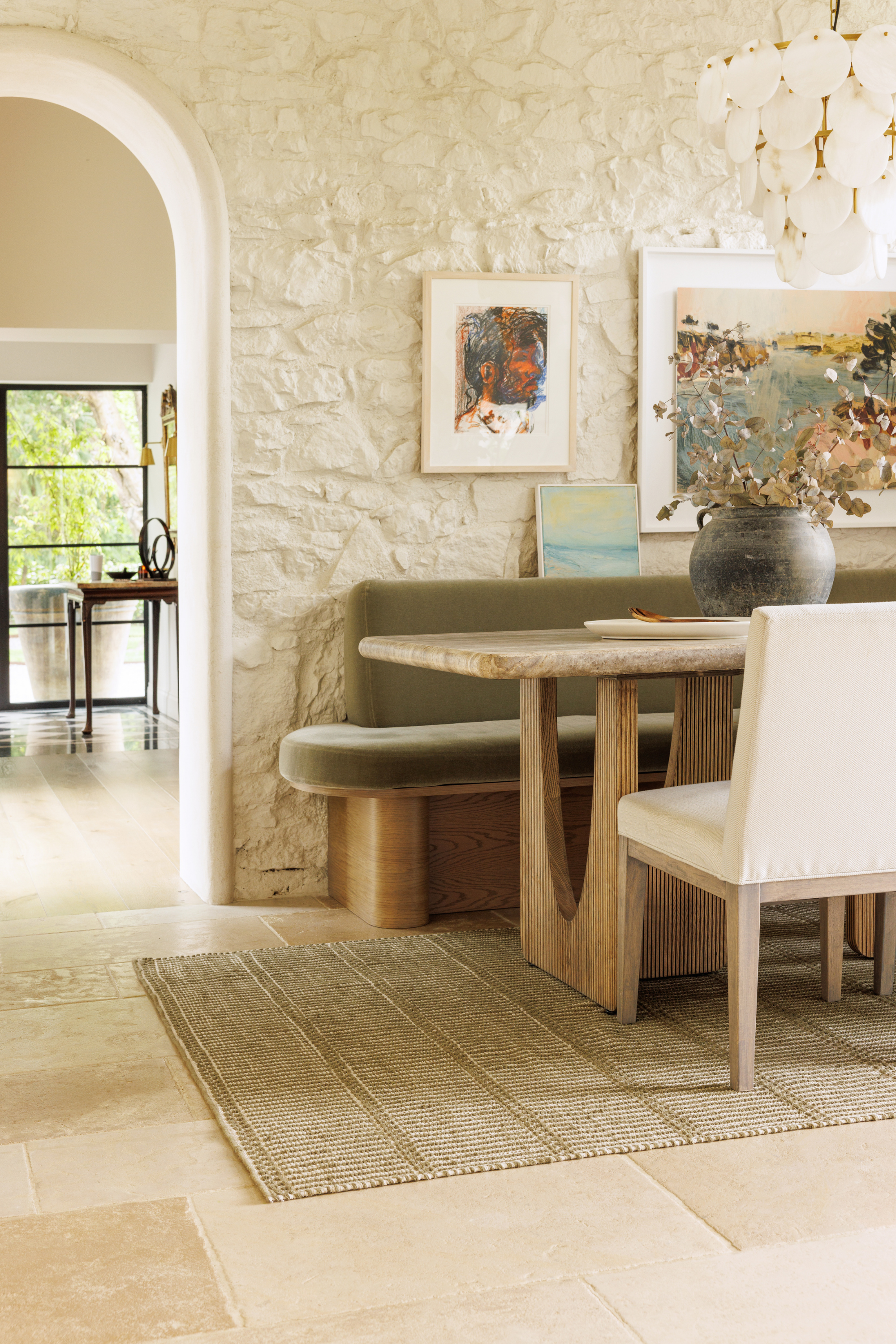 wool and cotton rug in dark green moss tones featuring a design inspired by ancient irish script placed under a dining table