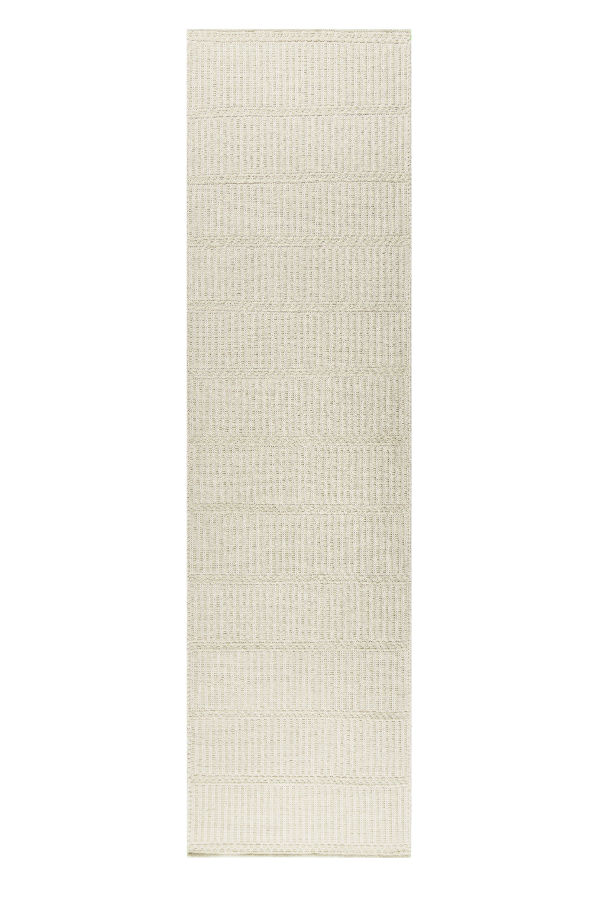 wool and cotton runner rug in soft olive hues featuring a design inspired by ancient irish script