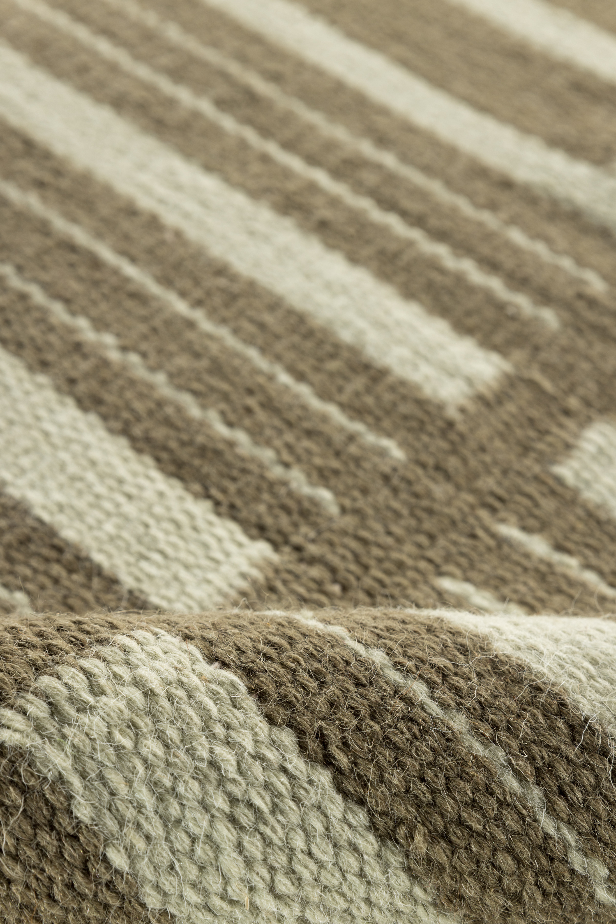 Tonal green wool and cotton rug featuring a contrasting linear pattern