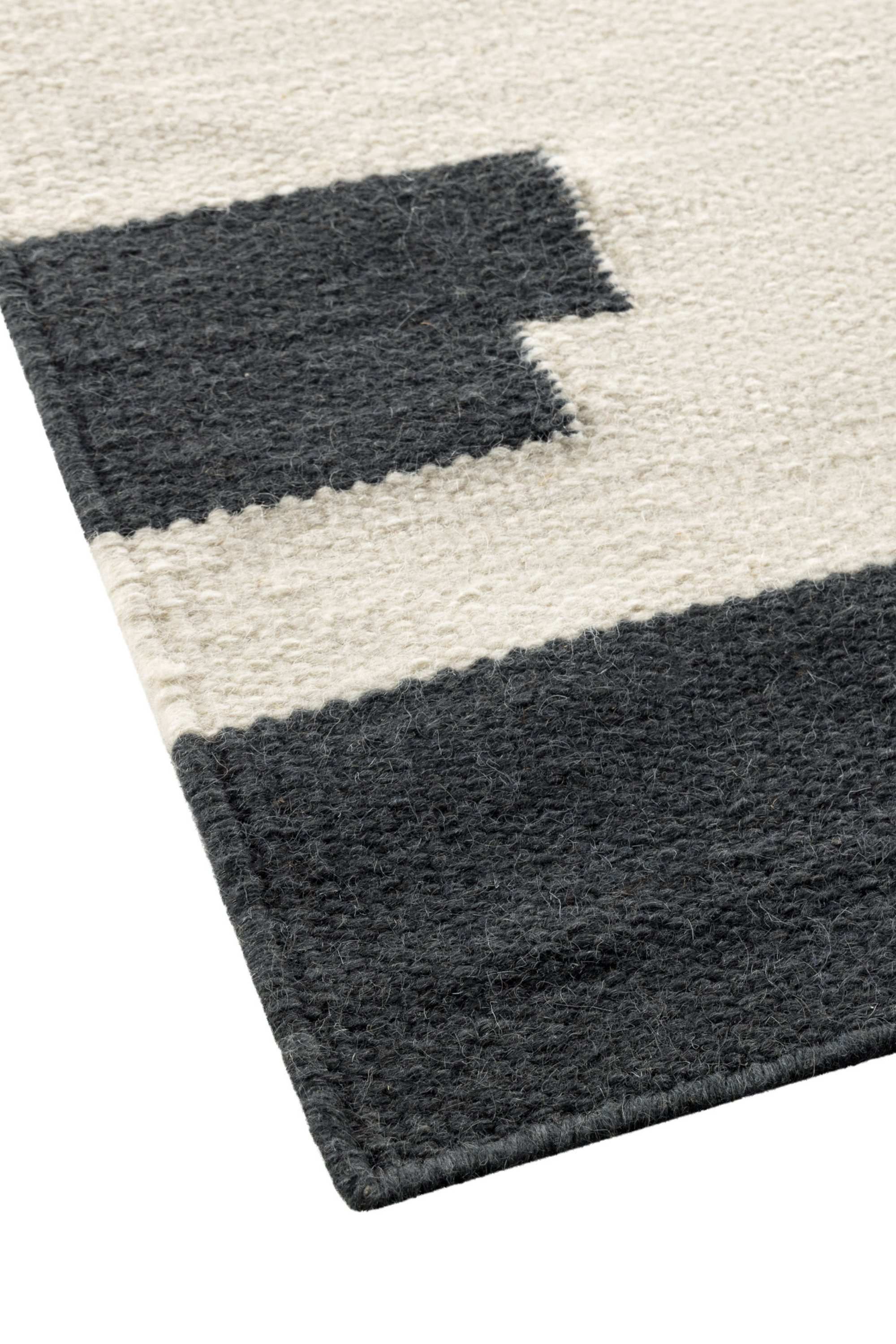 a black and white wool and cotton rug featuring a monochromatic modern abstract design