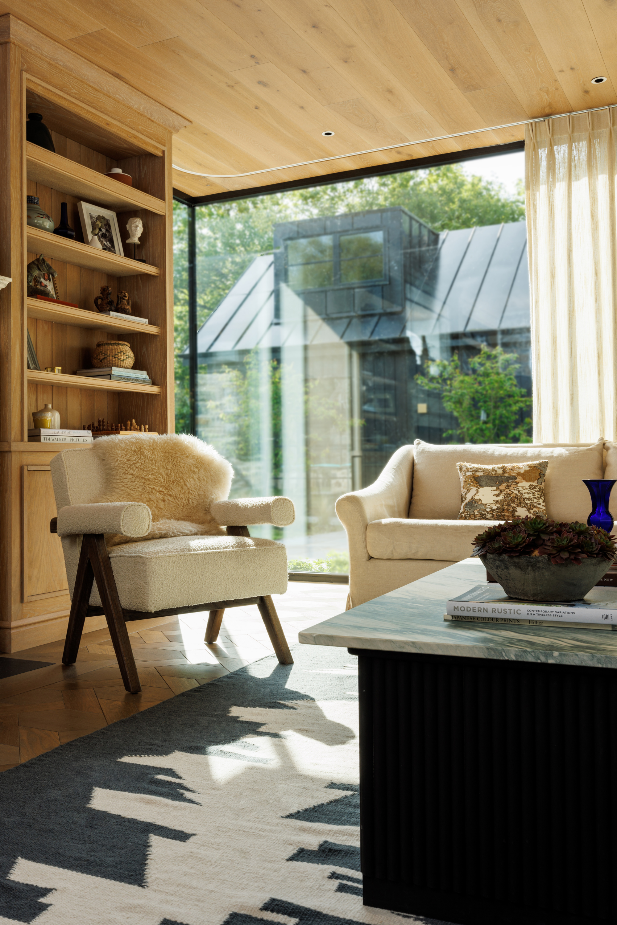 a black and white wool and cotton rug featuring a monochromatic modern abstract design placed in a living room