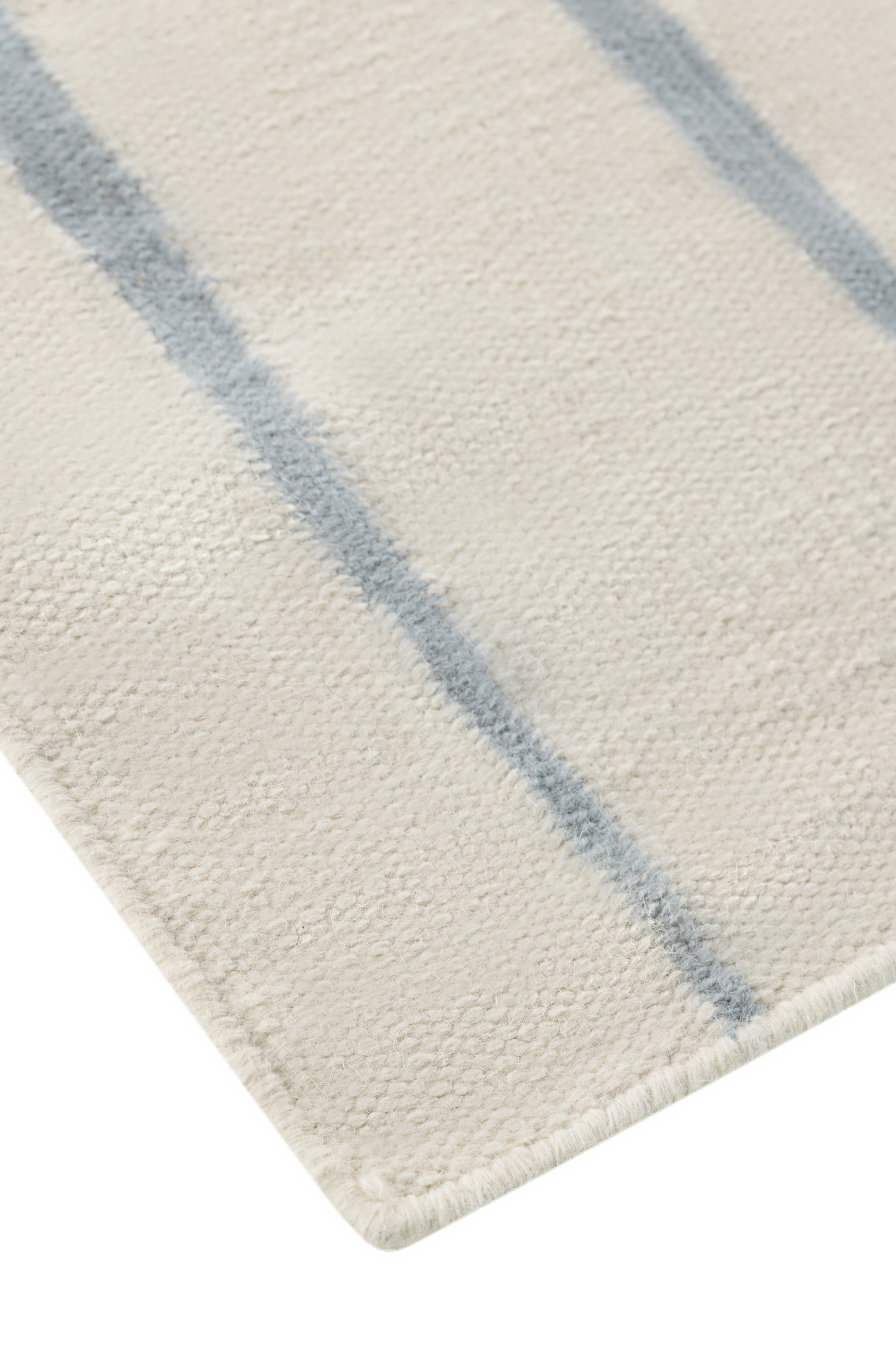 Neutral ivory wool and cotton flatweave rug featuring blue ripple linear lines