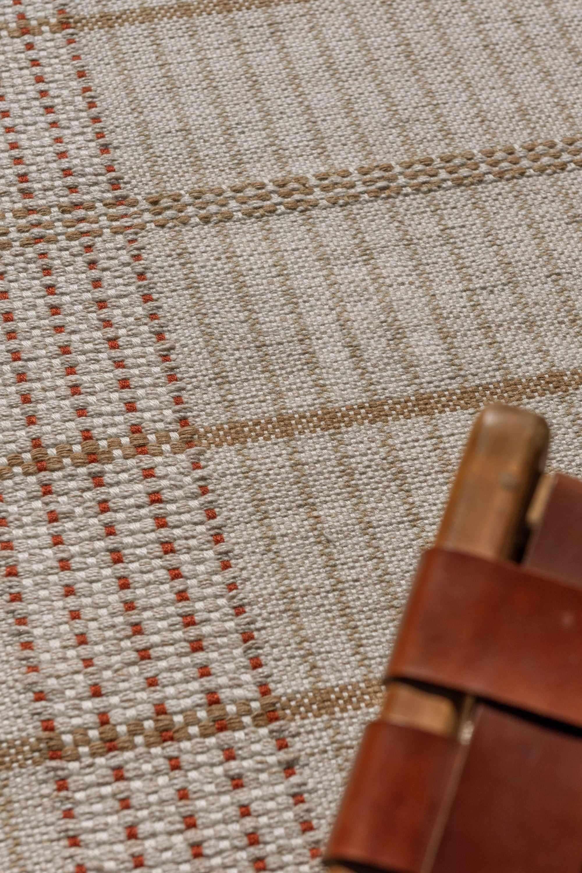 Modern beige geometric rug with brown pattern