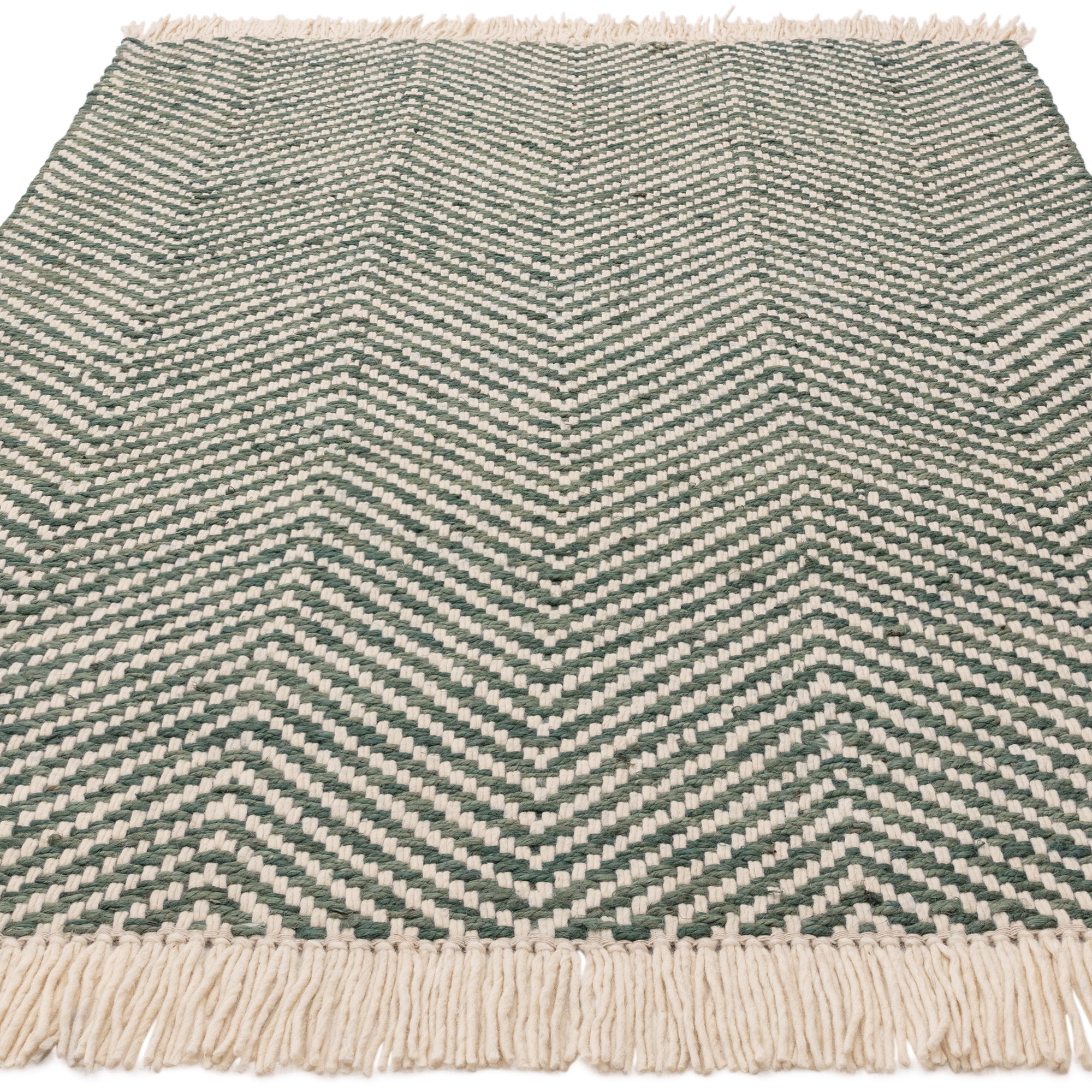 Textured woven rug with green and cream chevron pattern