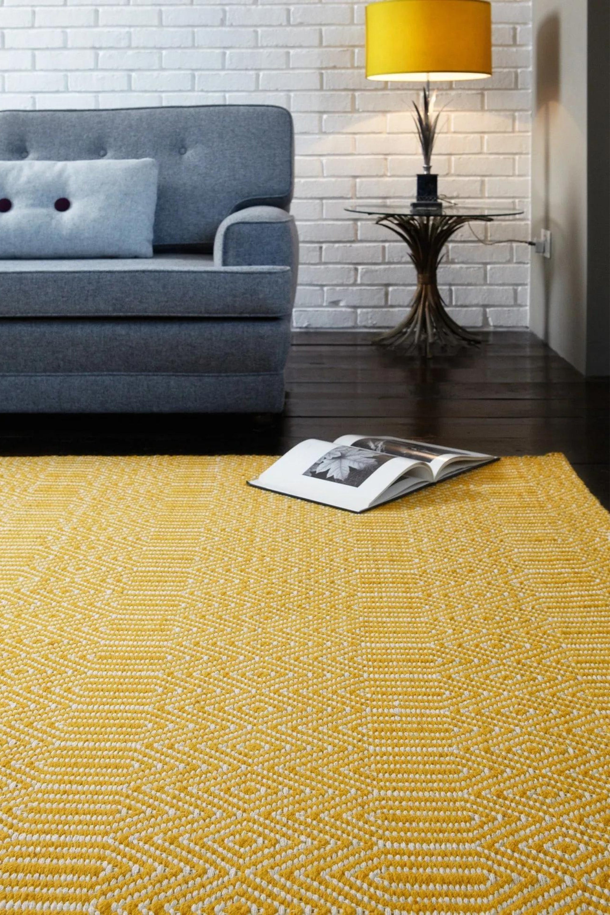 mustard yellow and white rug with a geometric aztec pattern