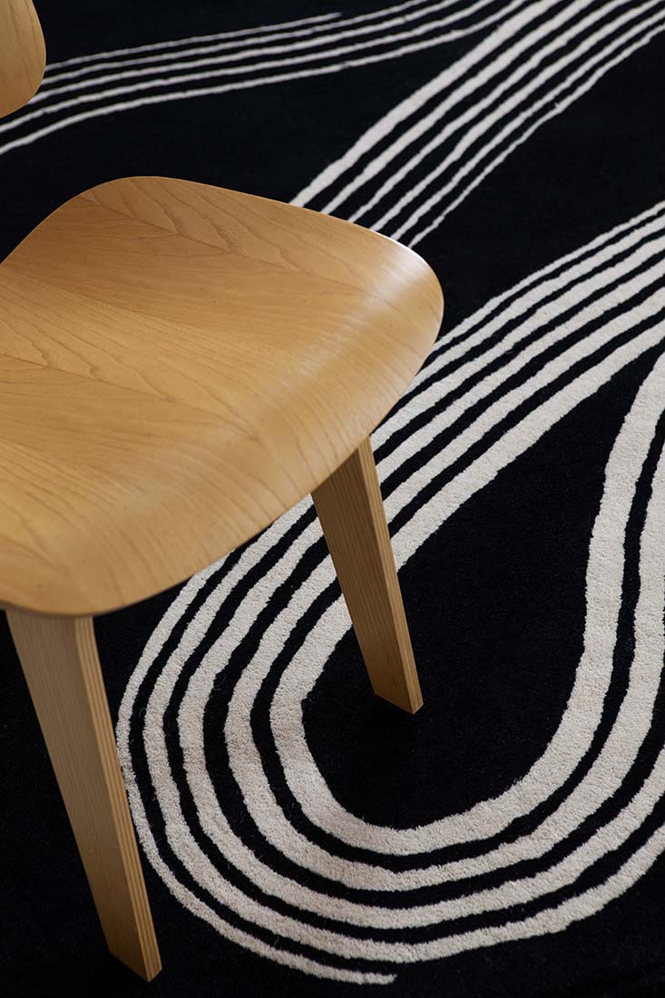 black rug with cream brush strokes