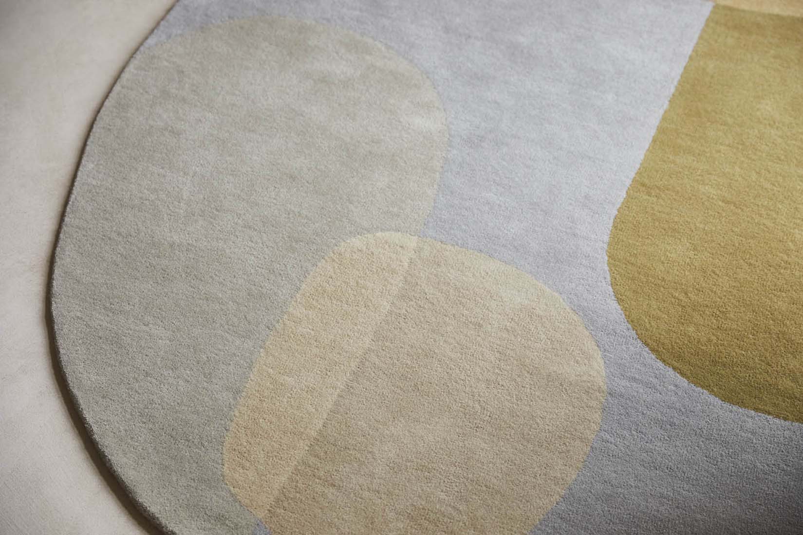 multicolour oval shaped wool rug with abstract design