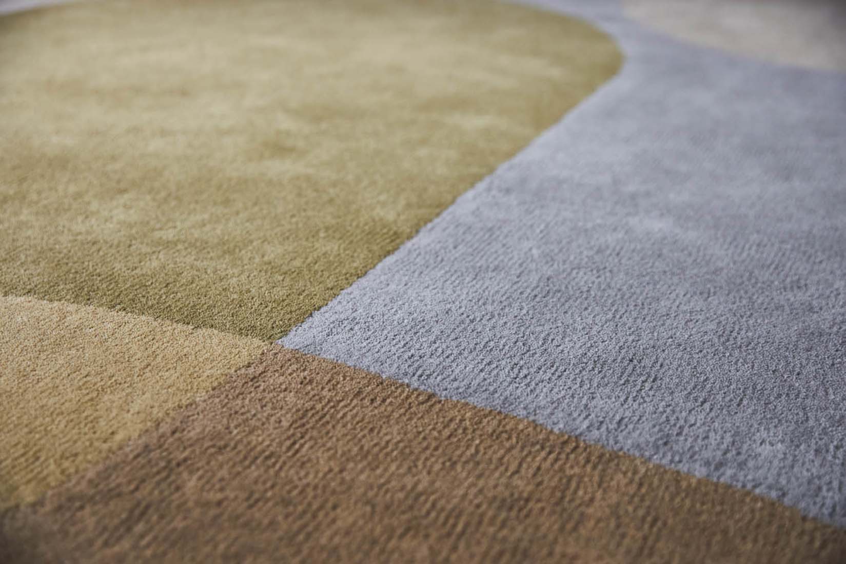 multicolour oval shaped wool rug with abstract design