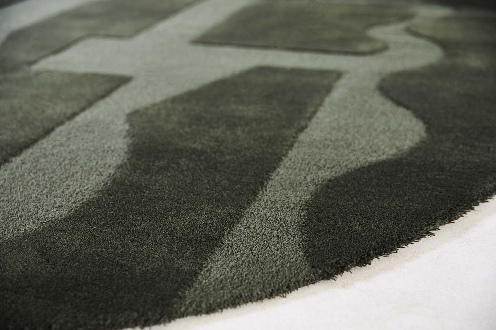 forest green wool rug with geometric textured design