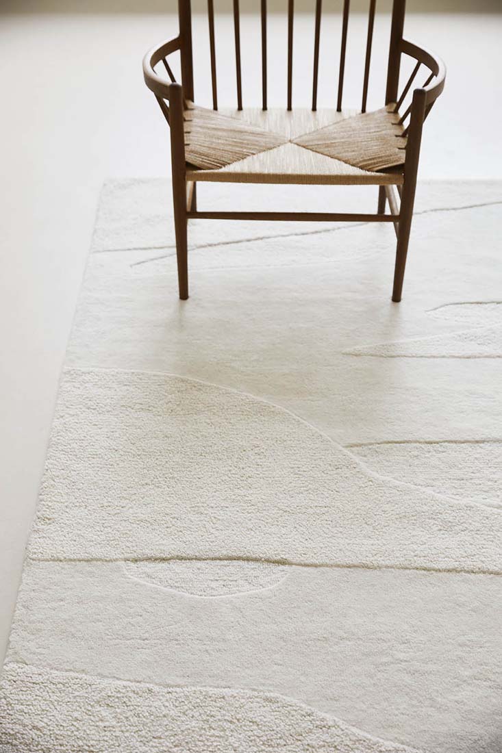 cream wool area rug with subtle texture detail