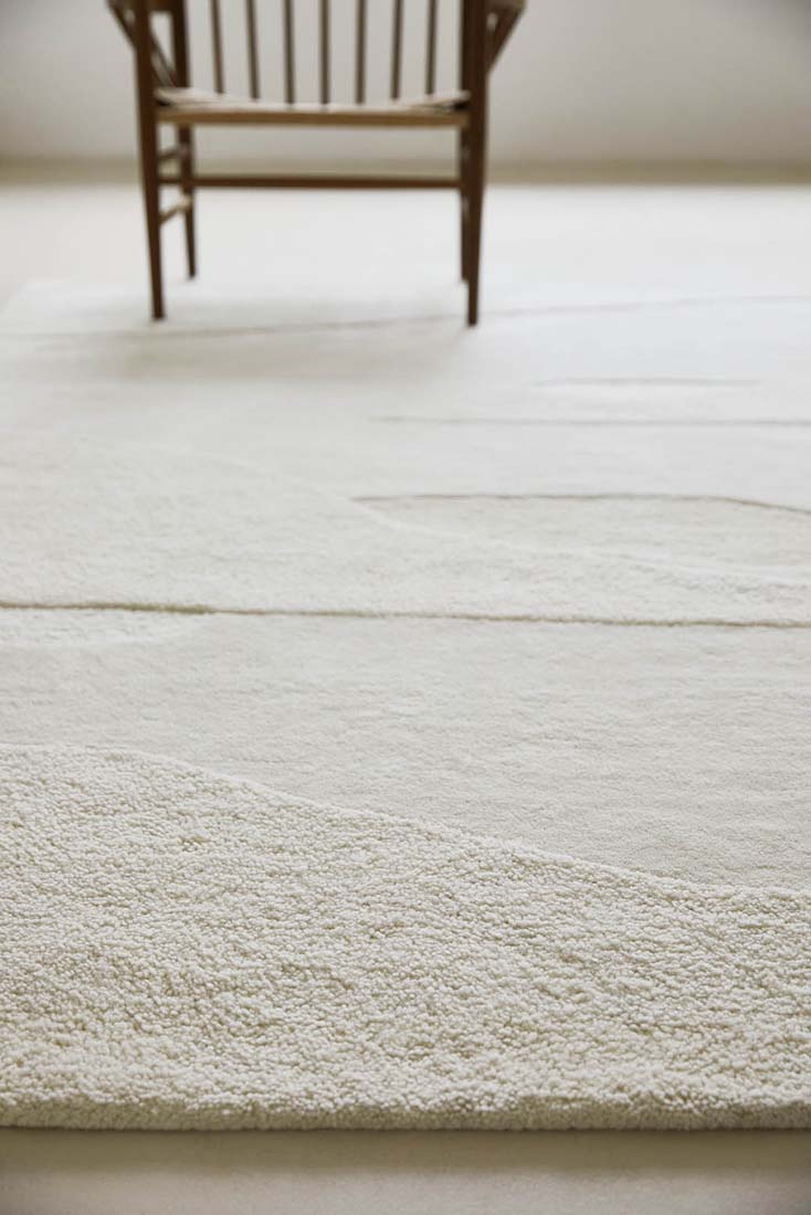 cream wool area rug with subtle texture detail