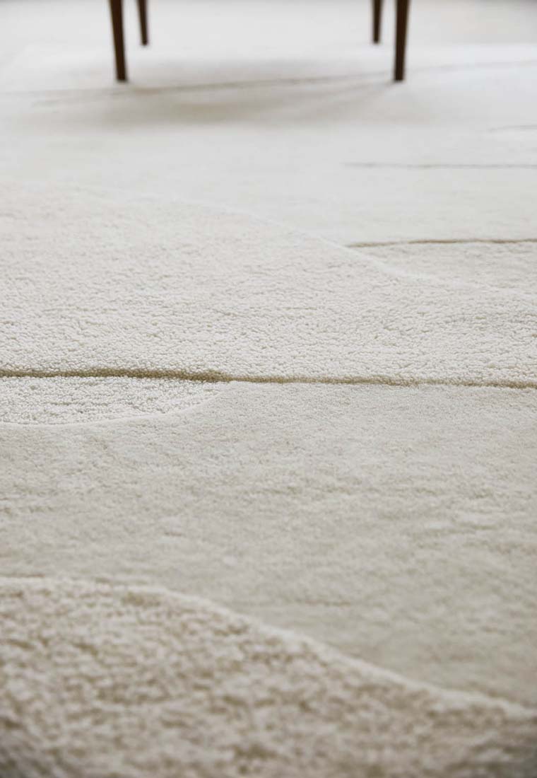 cream wool area rug with subtle texture detail