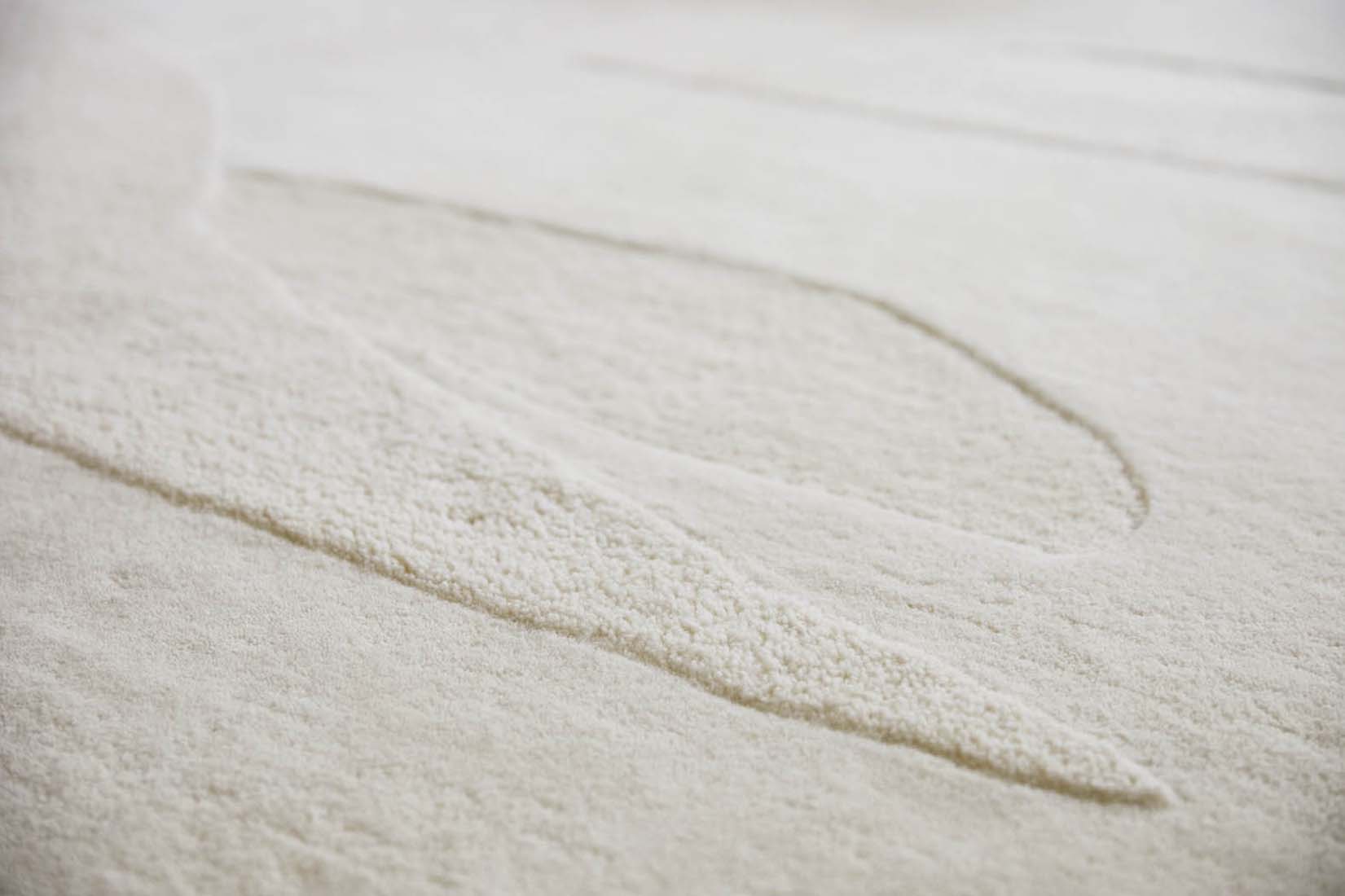 cream wool area rug with subtle texture detail