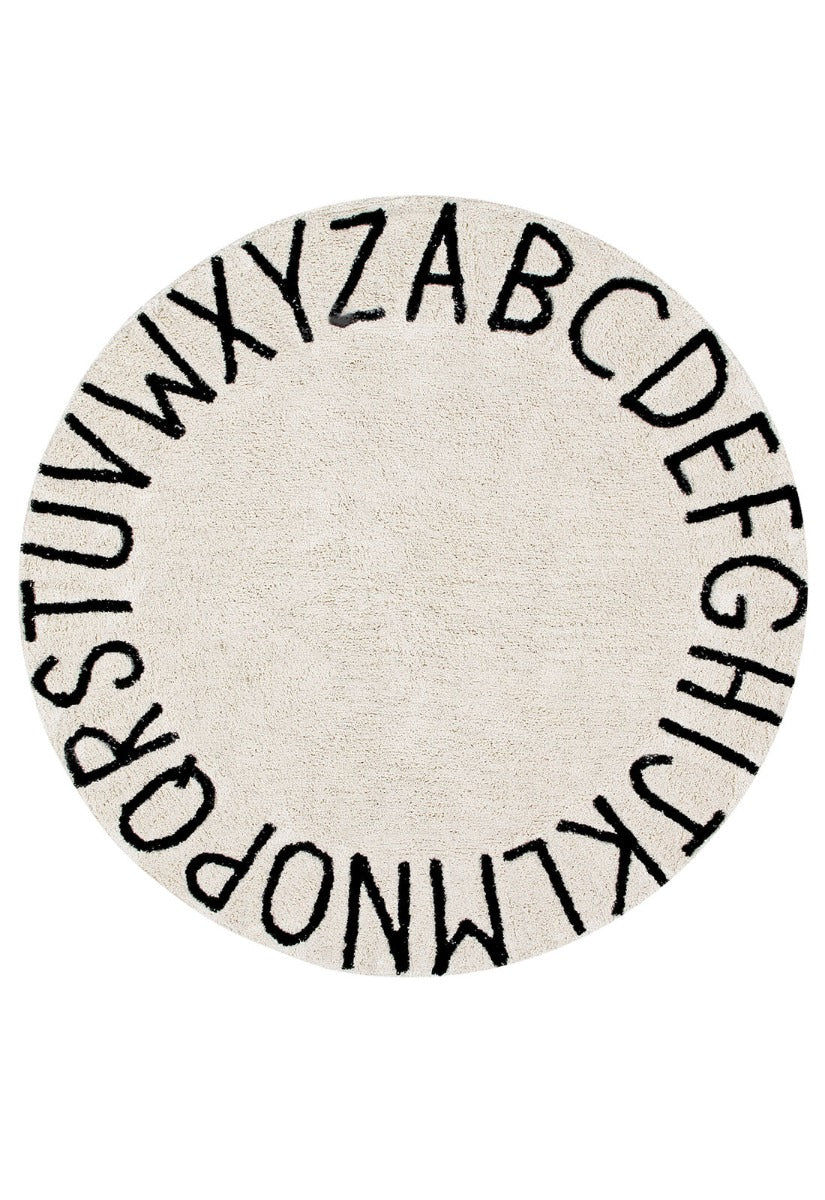 Circular white cotton rug decorated with a black alphabet border