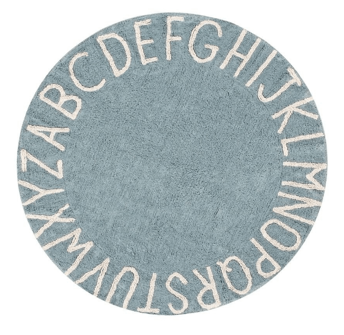 Circular blue cotton rug decorated with a natural beige alphabet border
