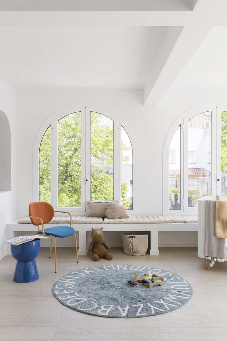 Circular blue cotton rug decorated with a natural beige alphabet border