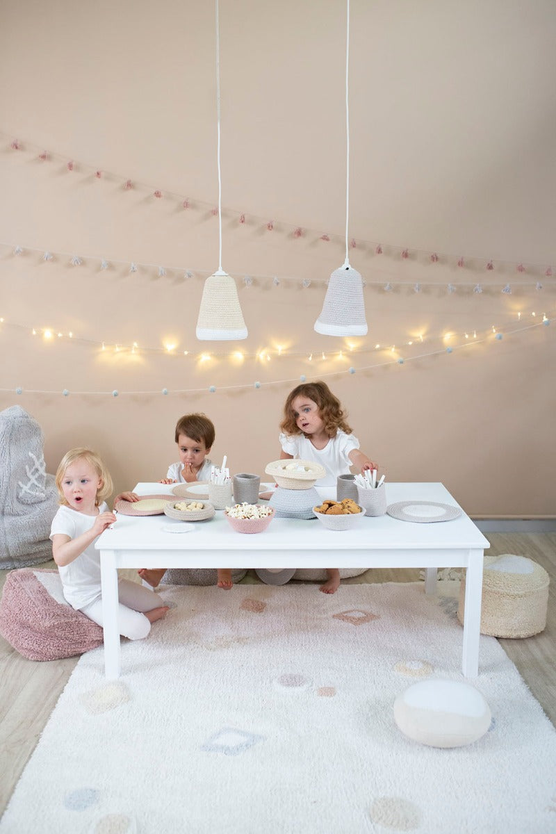 white lorena canals cotton rug decorated with shapes and tassels