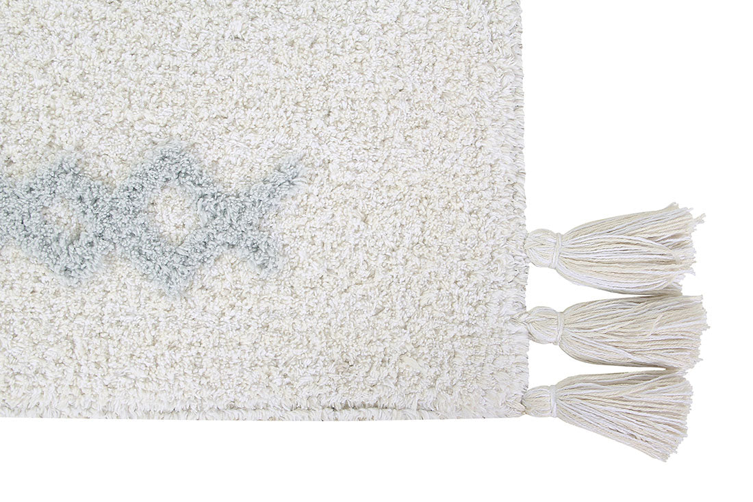 white lorena canals cotton rug decorated with shapes and tassels