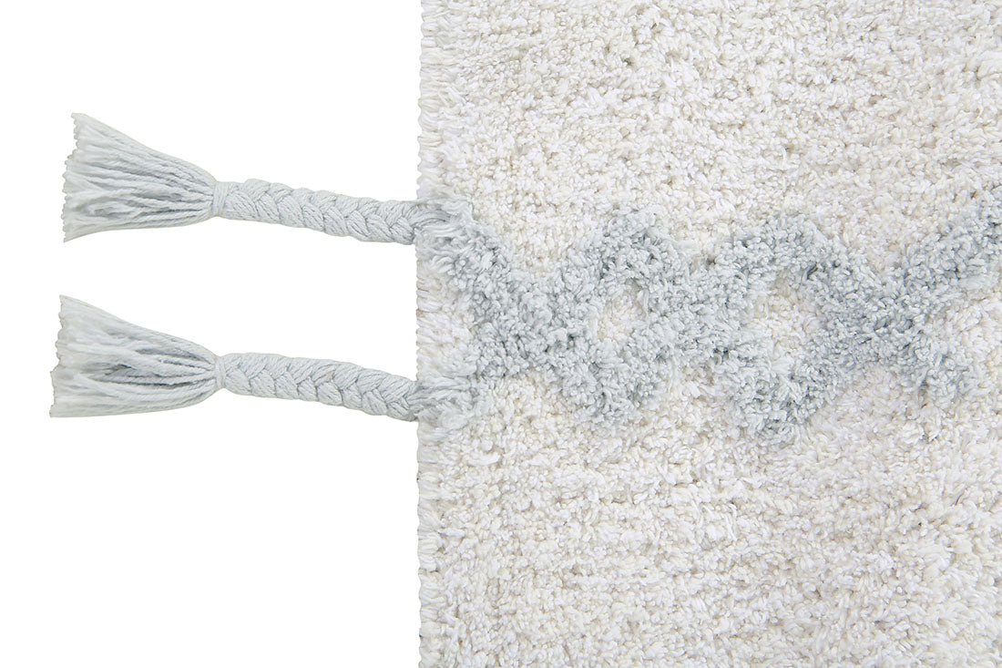 white lorena canals cotton rug decorated with shapes and tassels