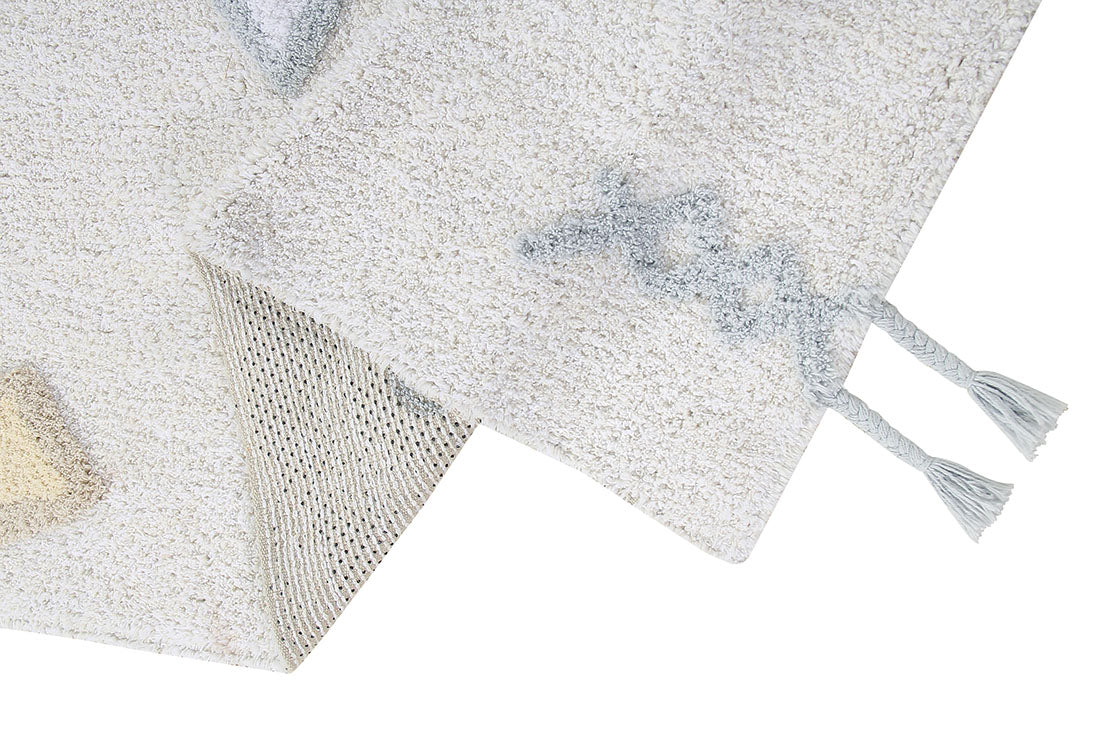white lorena canals cotton rug decorated with shapes and tassels