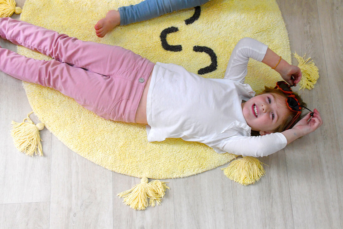 cotton tufted round rug shaped as a smiling sun